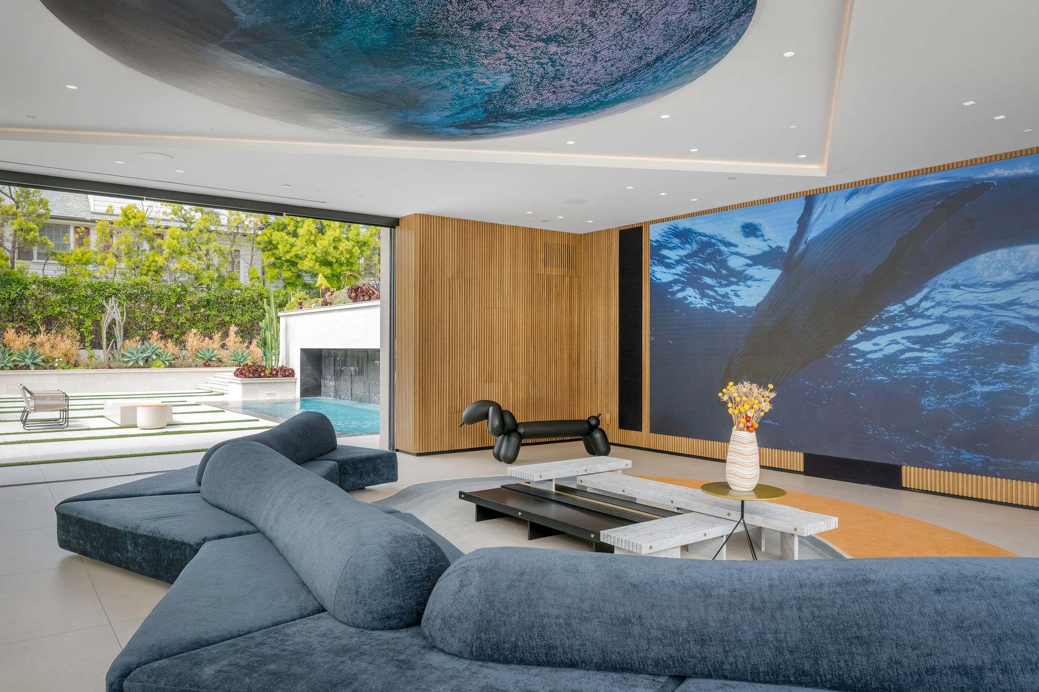 Private media room with large-format video wall and built-in seating.