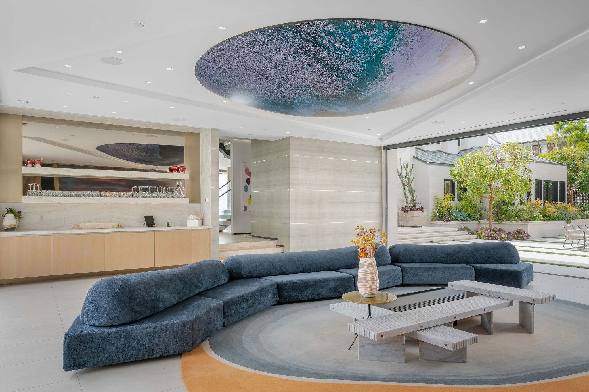 Media lounge with custom ceiling installation and oversized sectional seating.