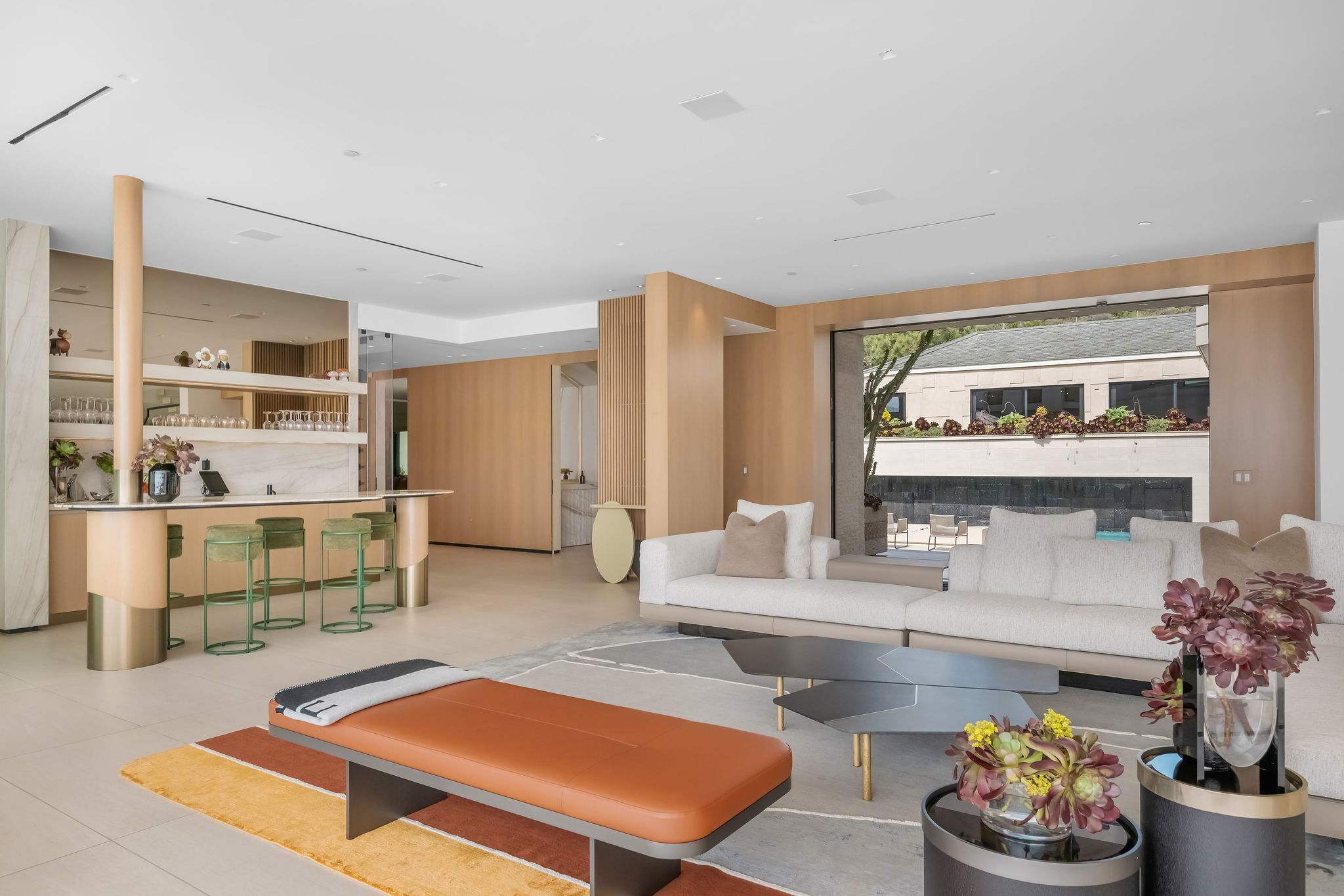 Open living and with integrated bar and custom design finishes.