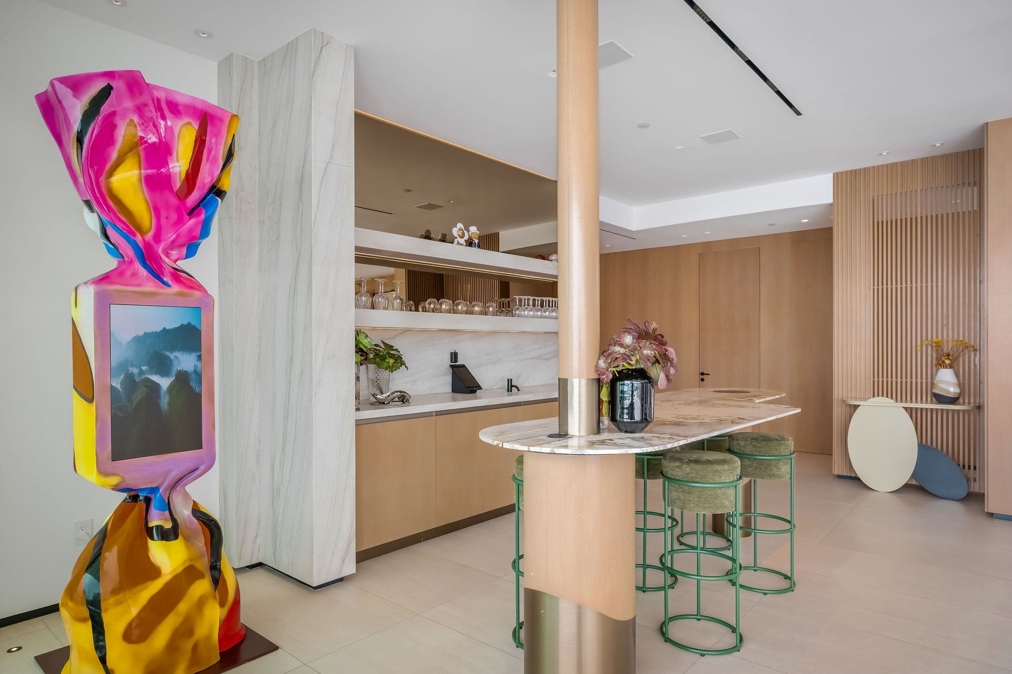 Statement bar area with sculptural artwork and built-in wine storage.