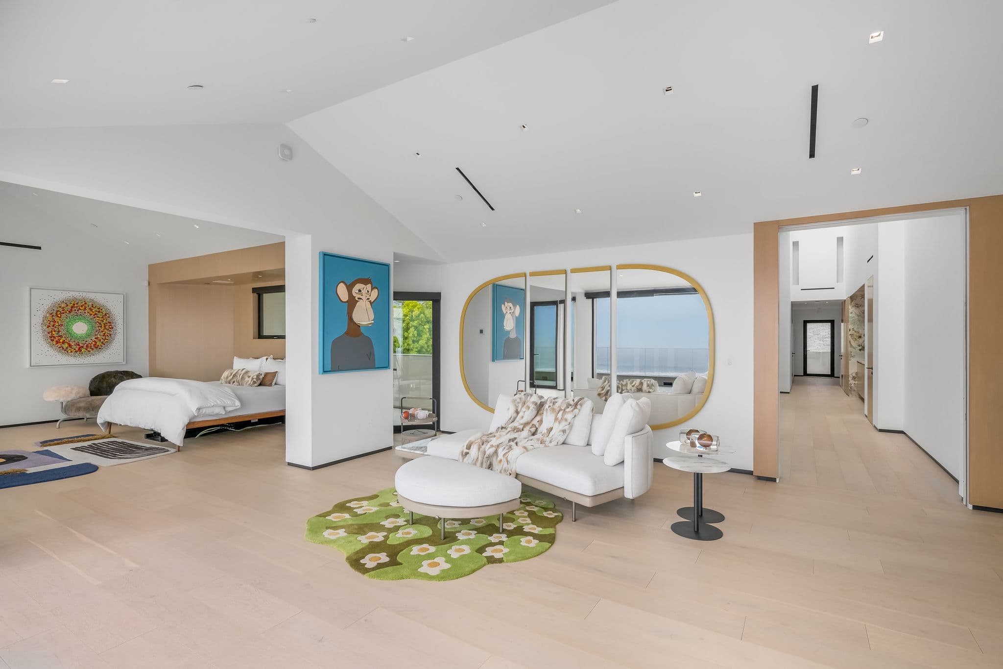 Bedroom suite with private lounge seating and curated design elements.