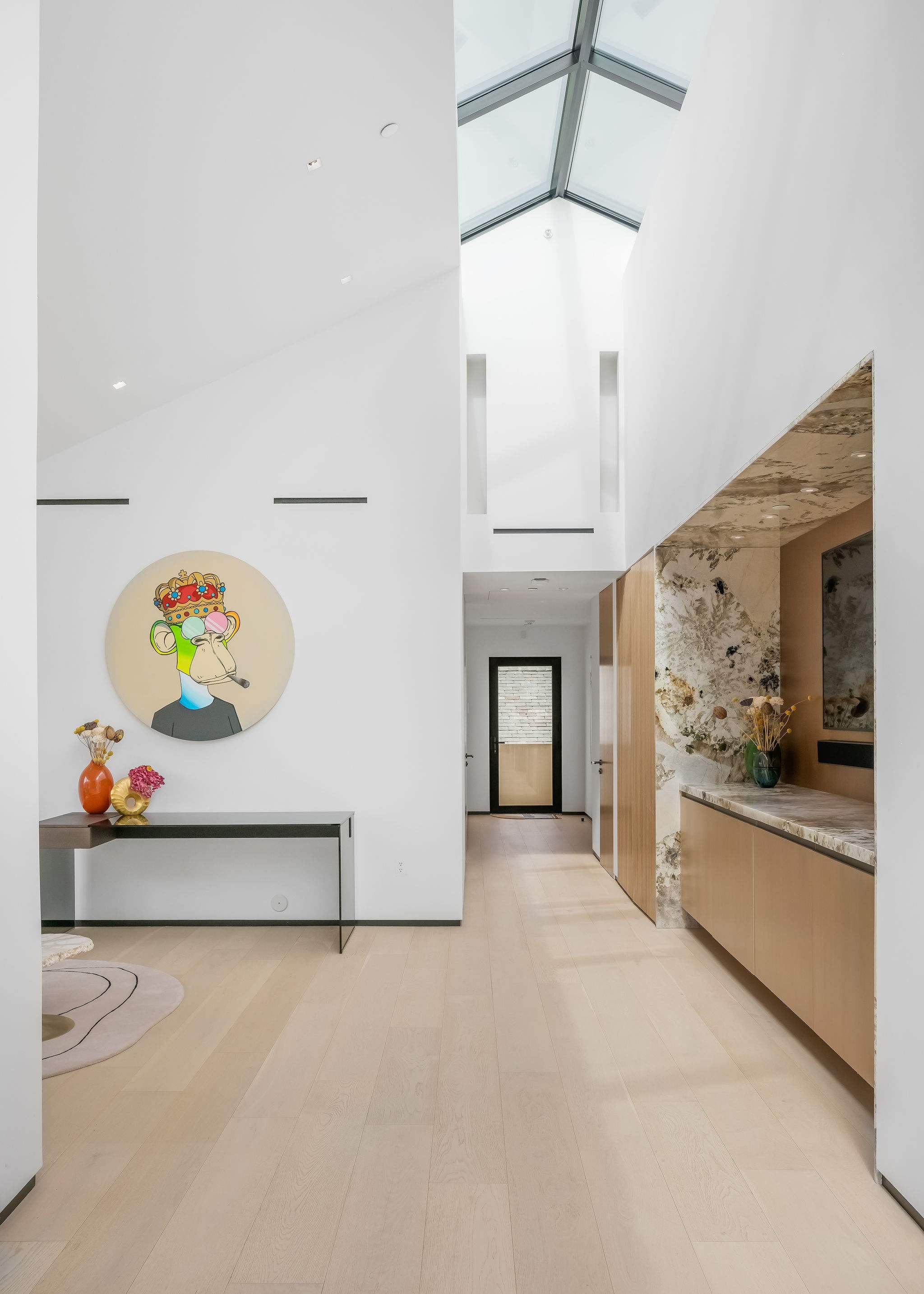 Gallery-style hallway with skylight feature and architectural detailing.