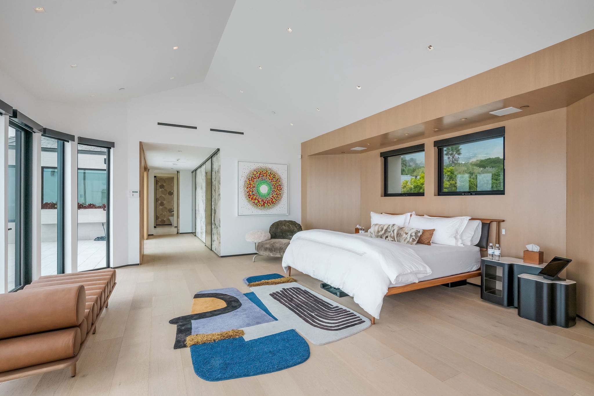 Guest bedroom with lounge seating and clean-lined modern design.