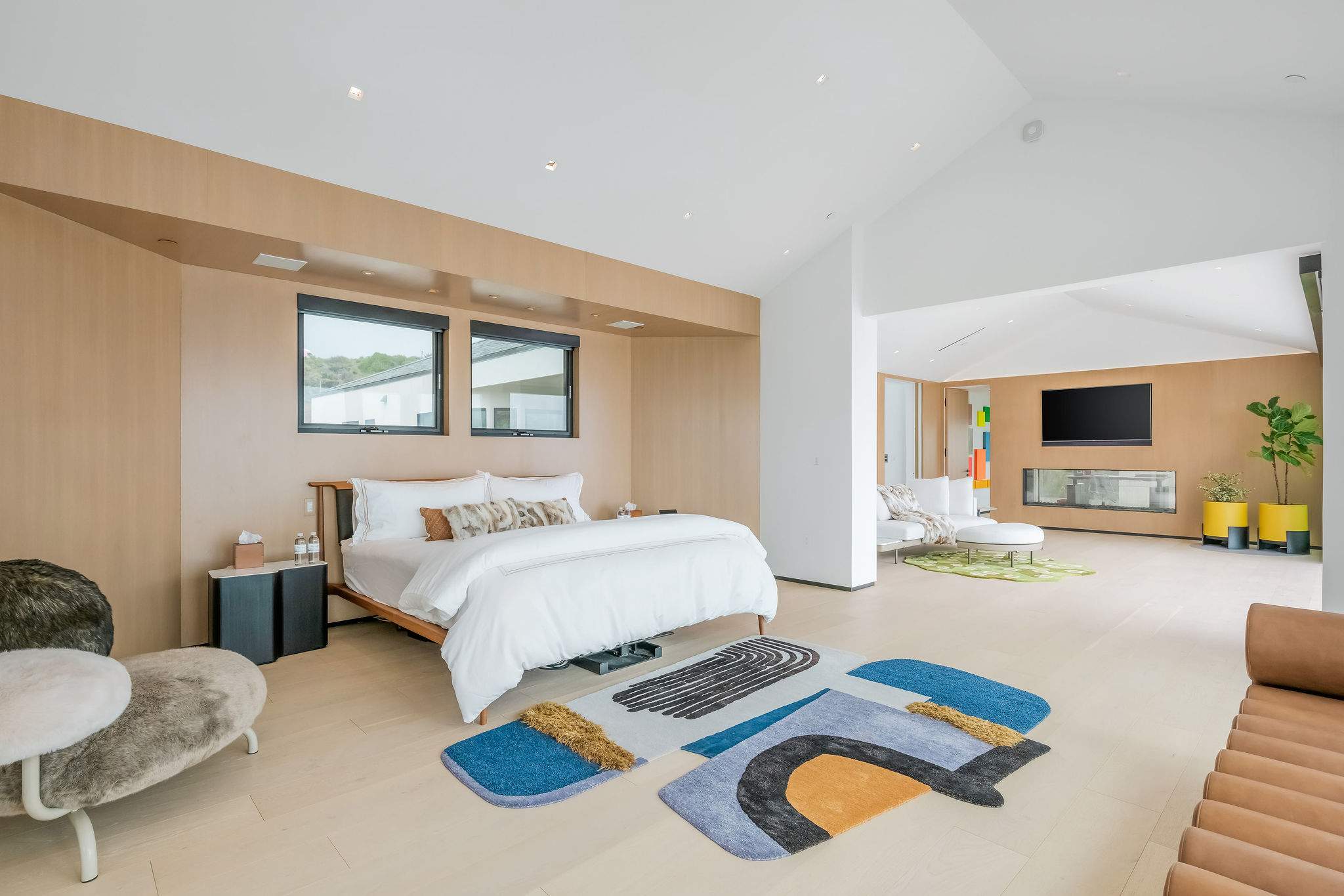 A spacious suite with lounge seating and a built-in fireplace, designed for elevated comfort.