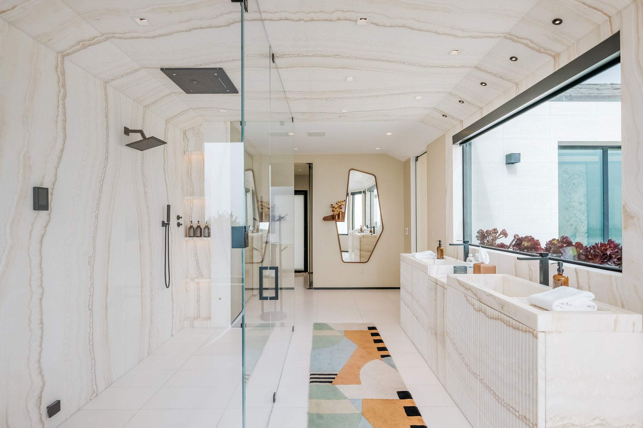 Spa-style bathroom with dual vanity, walk-in shower, and full-length layout.