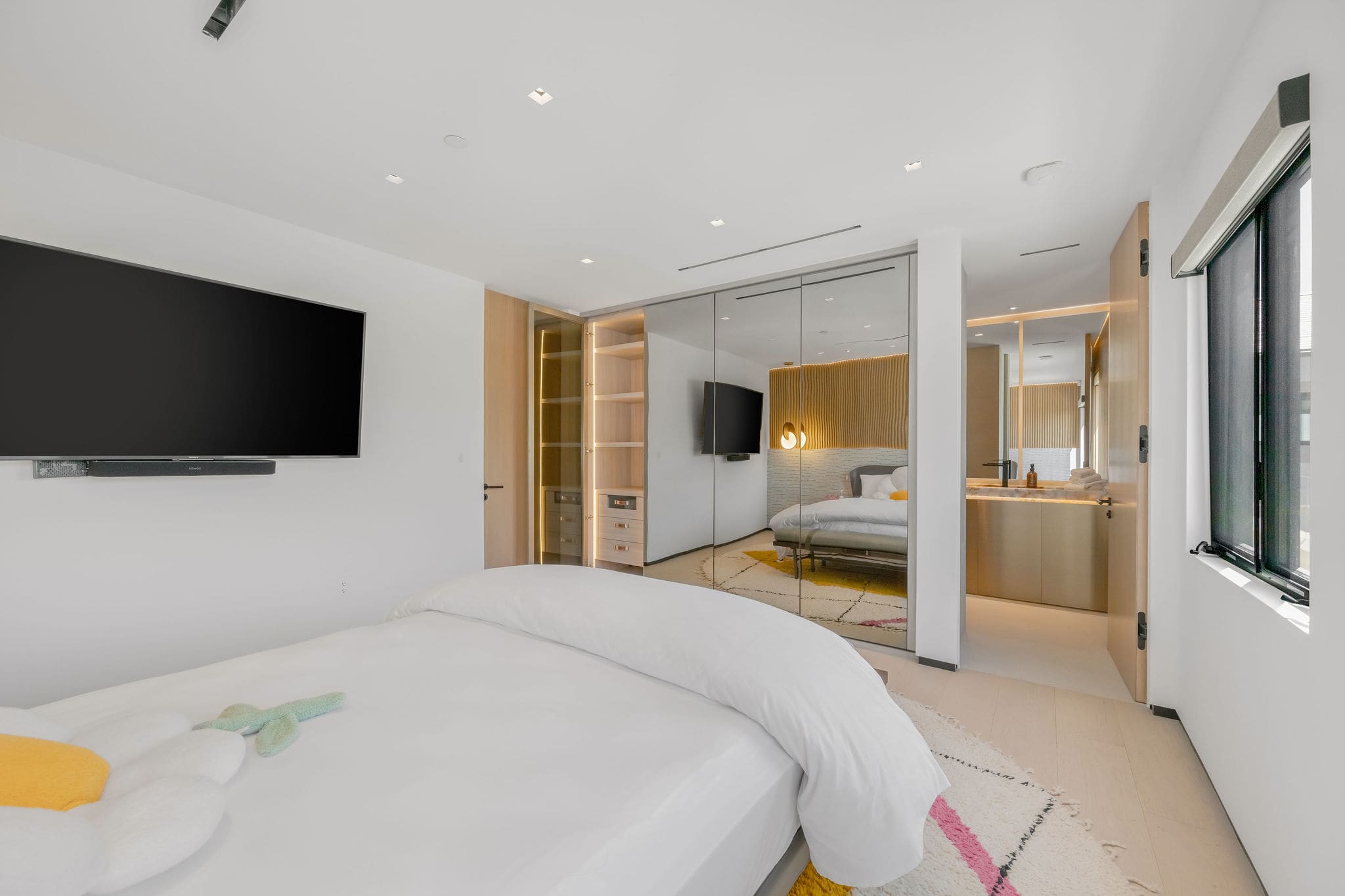 A bedroom with direct access to a spa-style bathroom, offering a seamless private suite layout.