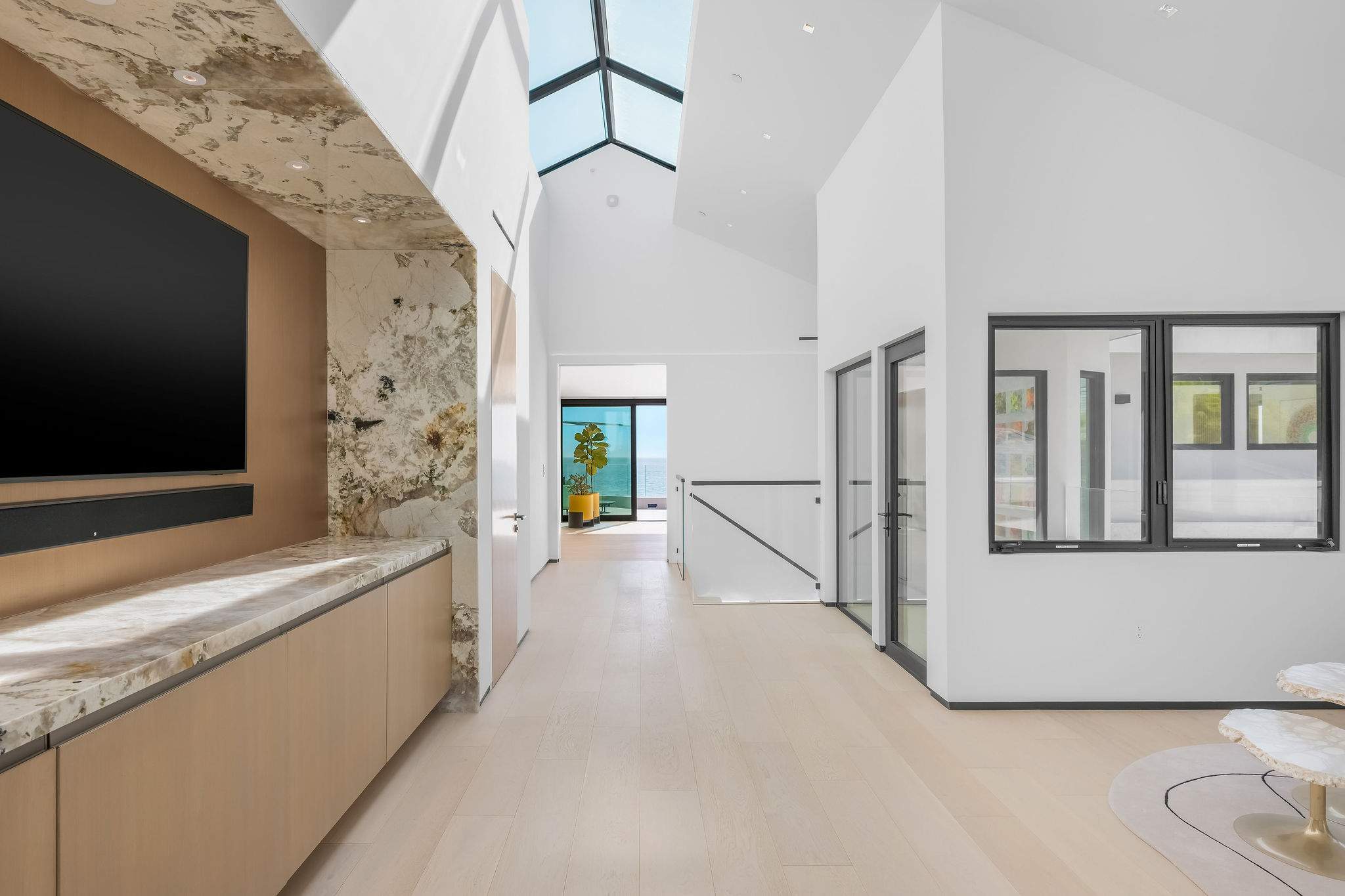 Architectural hallway with skylight feature and clean-lined interior design.