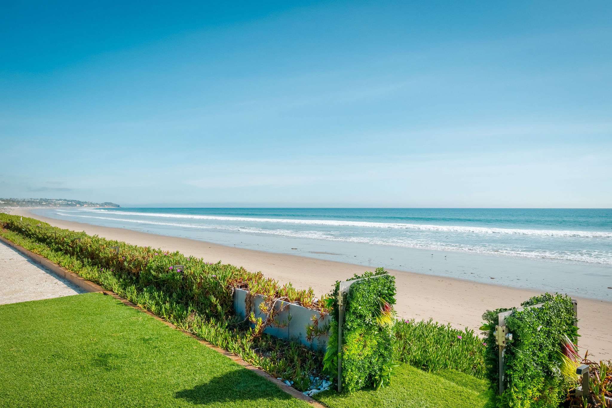 Step out onto the lawn with the beachfront just ahead.