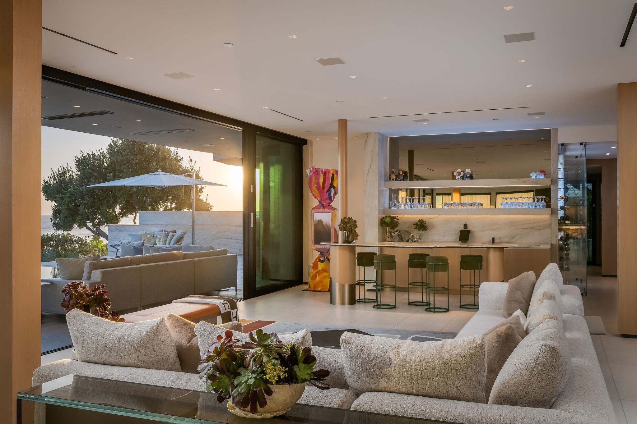 Lounge inside with the ocean-facing terrace extending just beyond the seating.