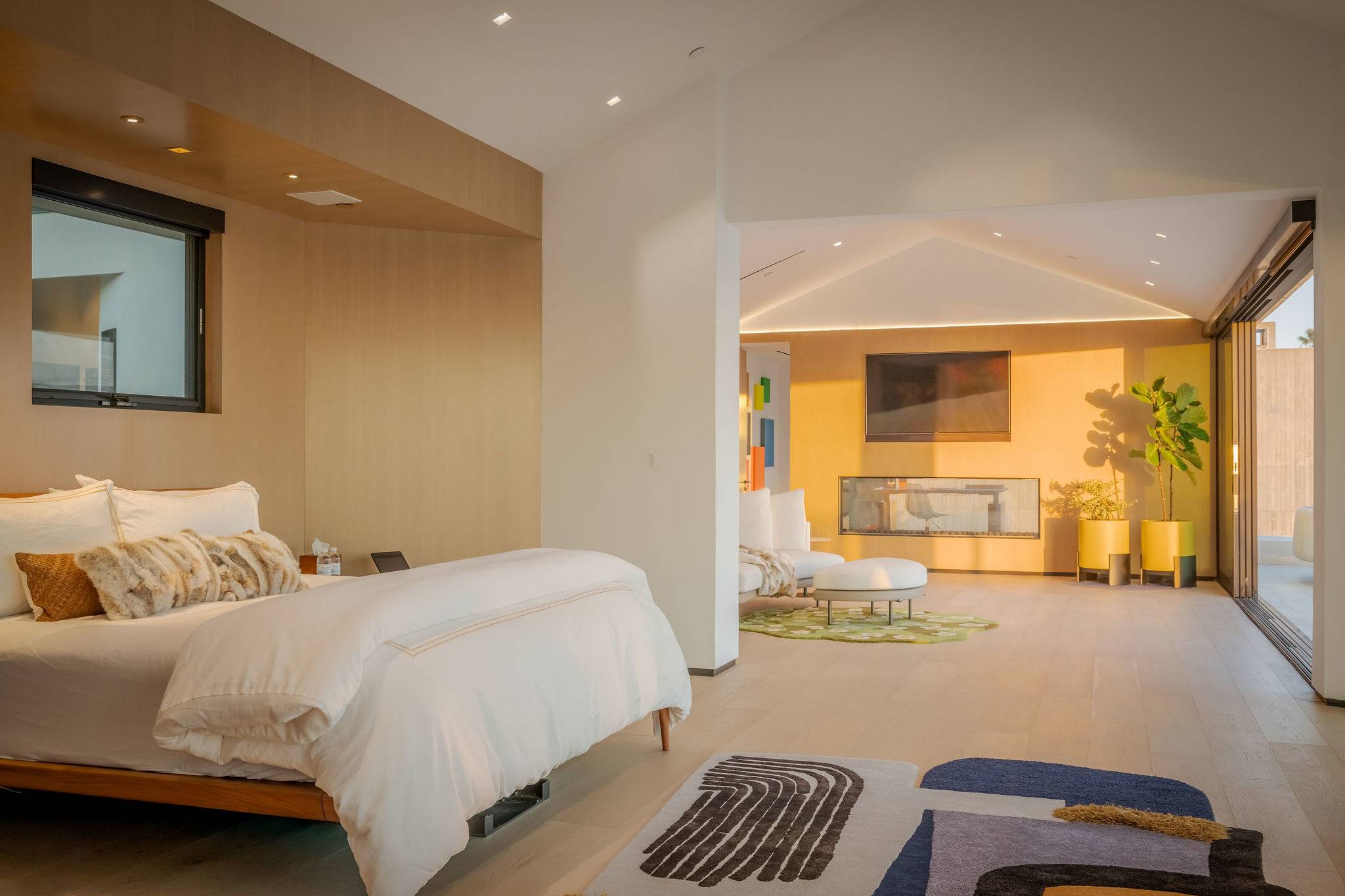 A bedroom suite connected directly to its own living area, all in one open layout.