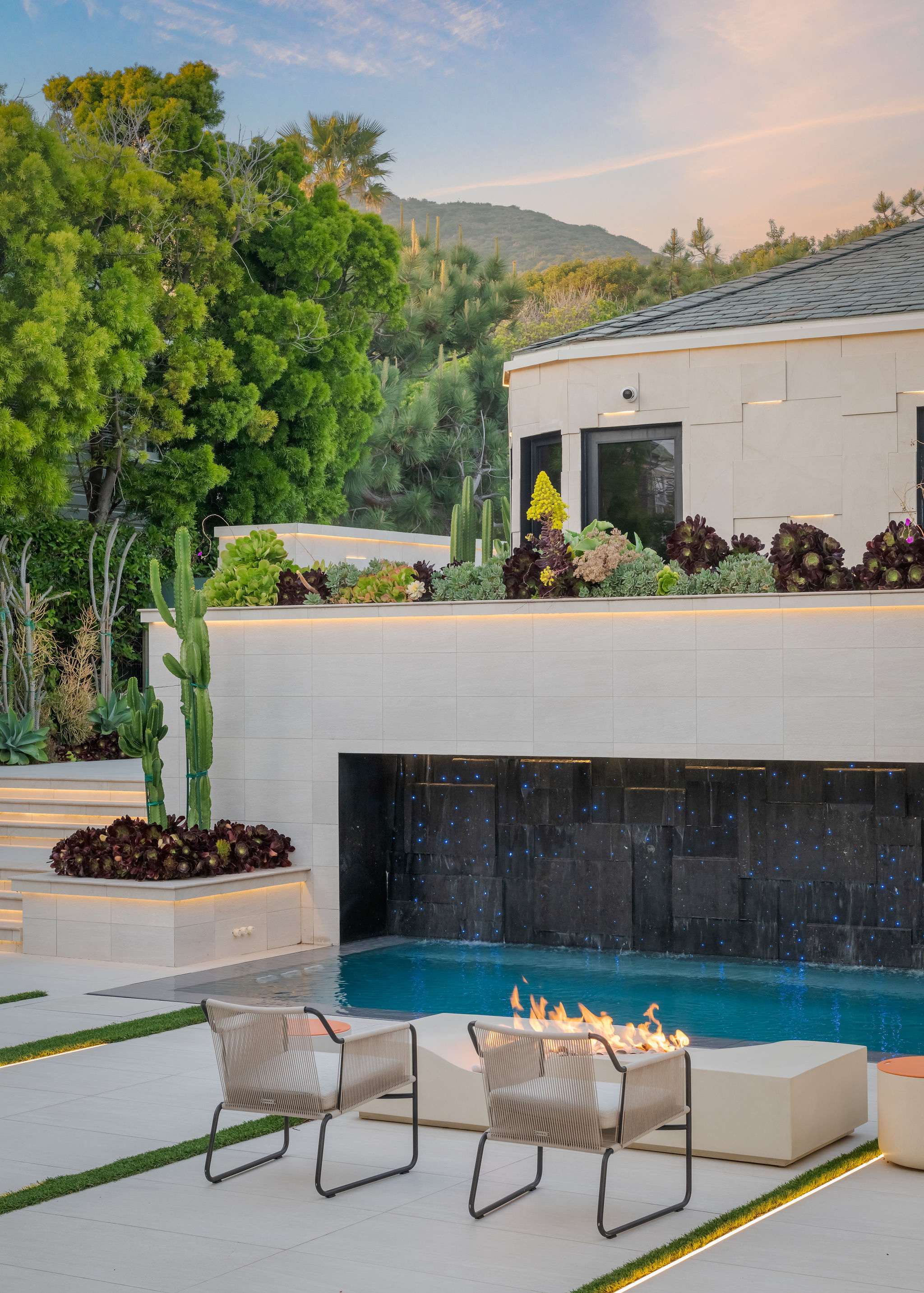 Courtyard water-wall with fire features and built-in lounge seating.