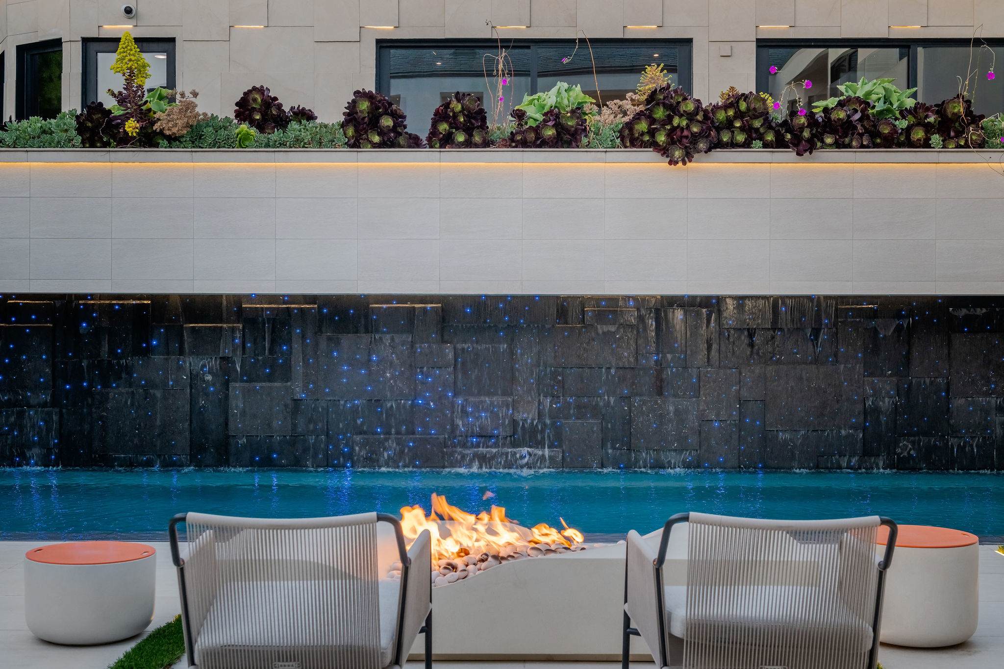 Fire, water, and pool lines meet in one outdoor setting set just off the main space.