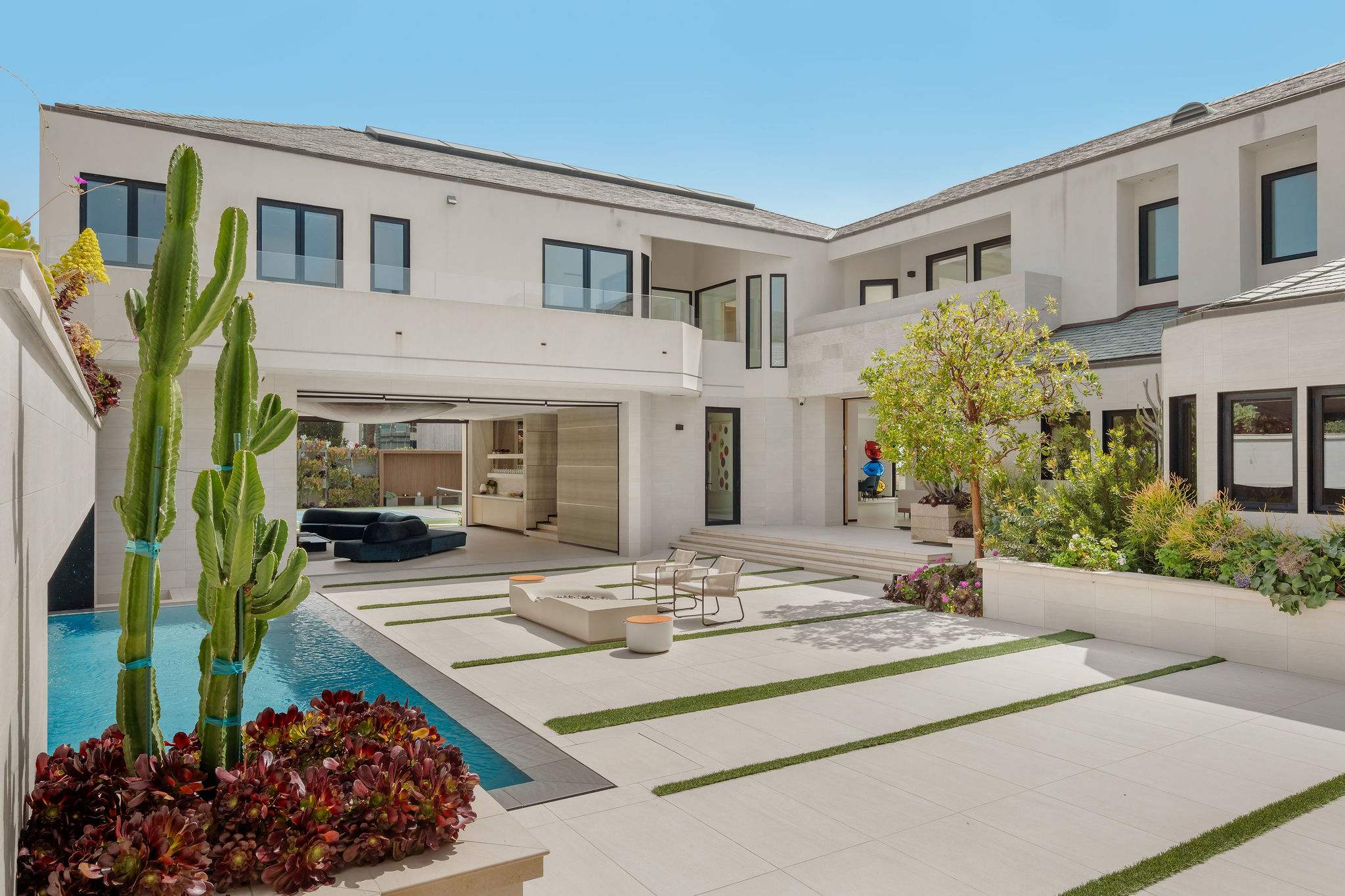 Private courtyard entry with landscaped design and central gathering space.