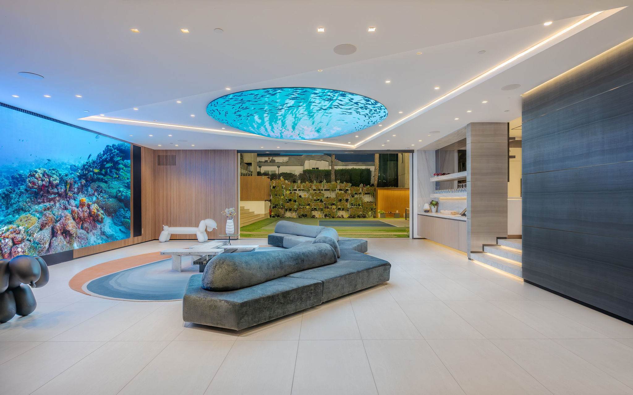 Media lounge with large-format video wall, integrated bar, and custom ceiling feature.