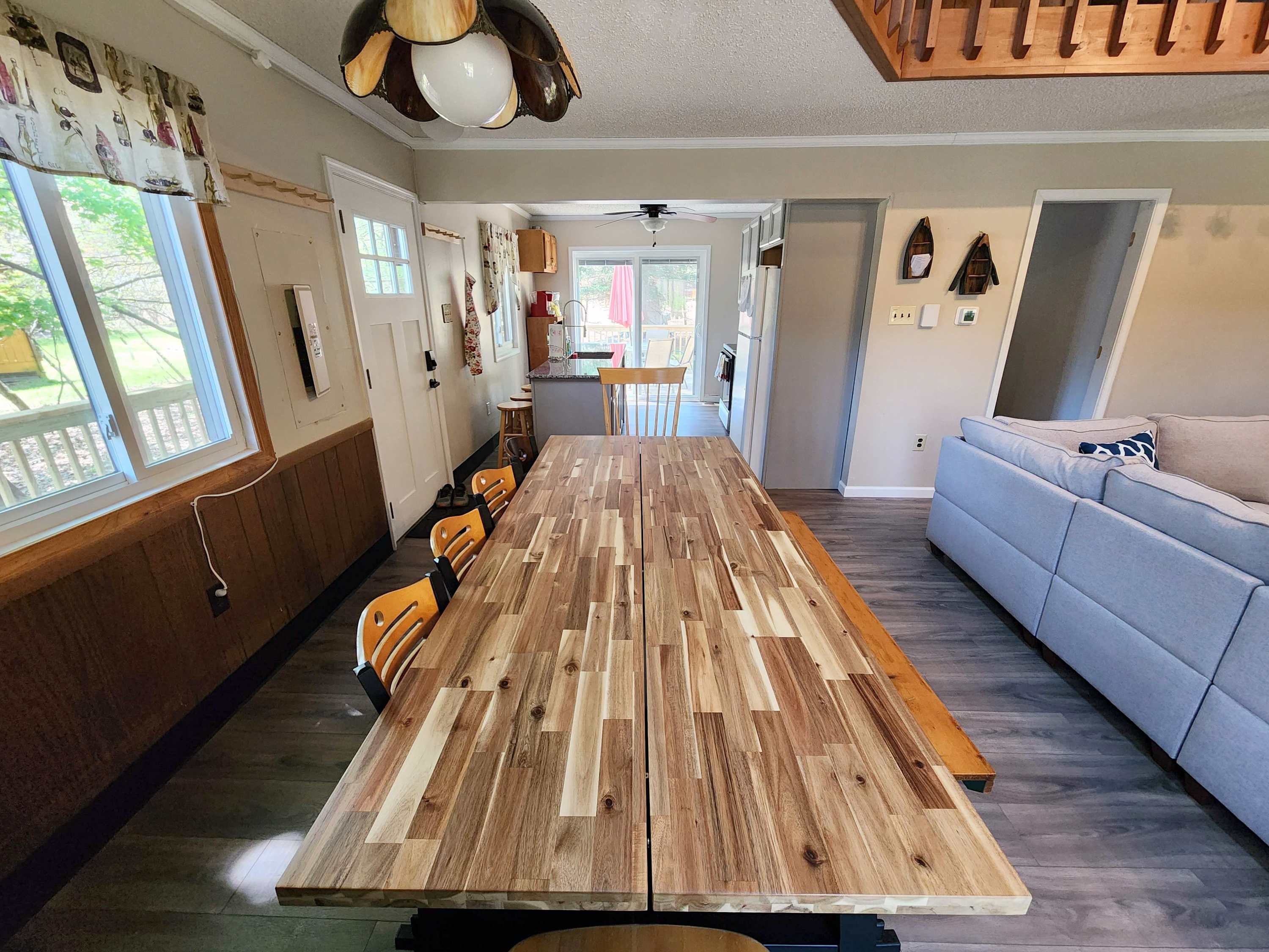 Gather for dinner at the long dining table with string lights setting the mood