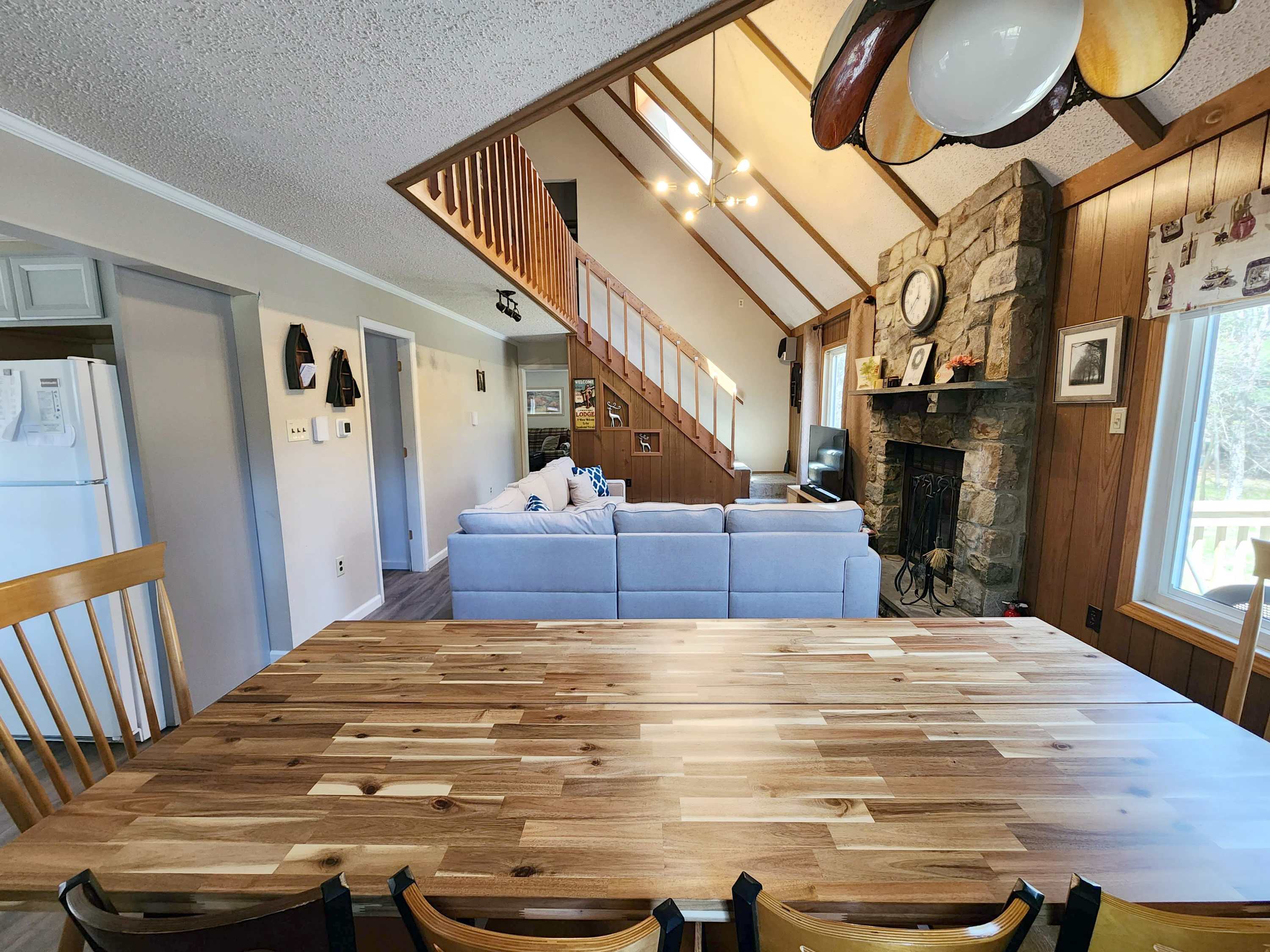 Spacious open dining area with vaulted wood ceilings and warm hardwood floors