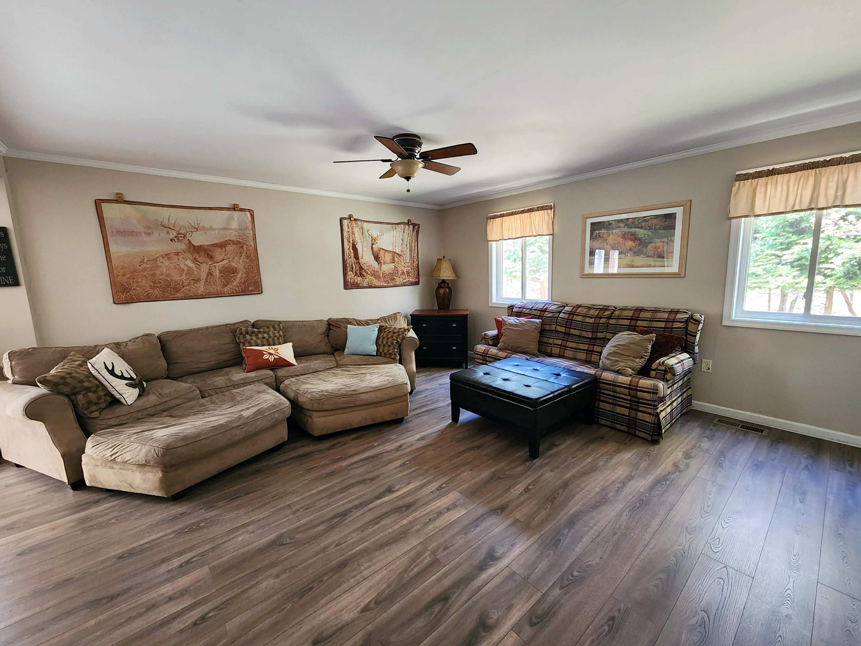Sunlit living room with oversized seating perfect for movie nights or lazy mornings