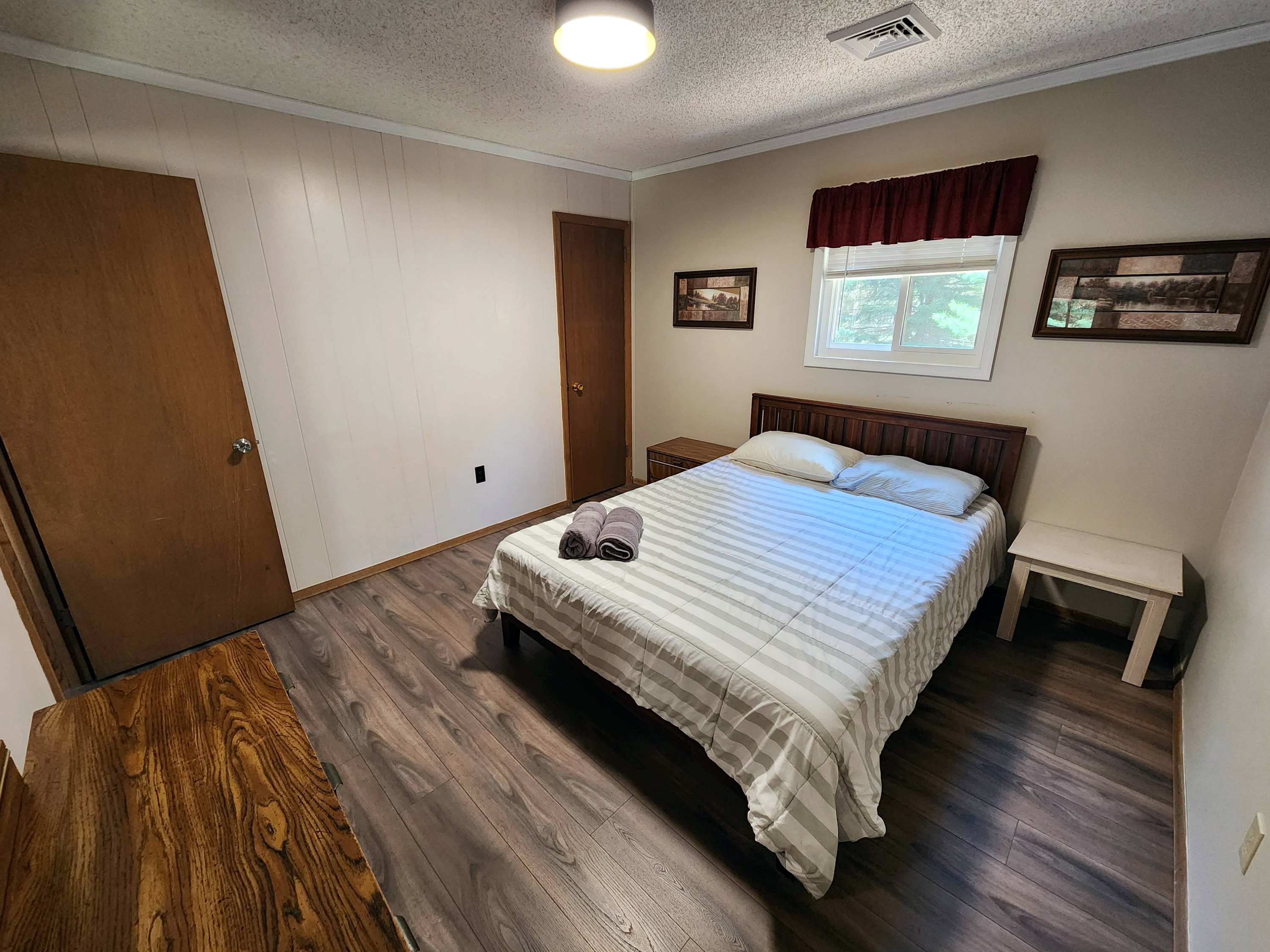 Simple and serene bedroom with crisp white bedding for a great night's sleep