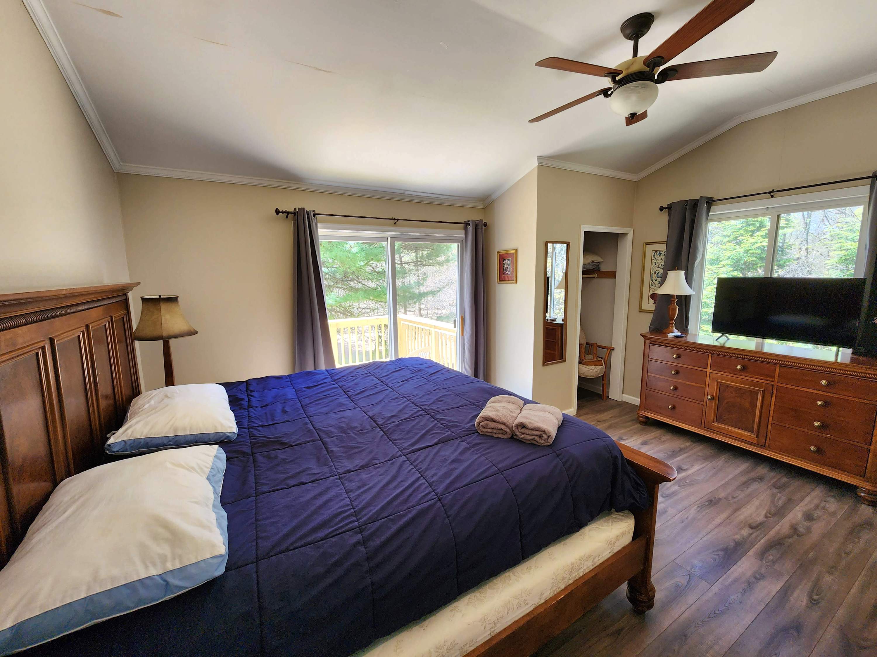 End the day in this calm retreat with rich blue bedding and a ceiling fan breeze