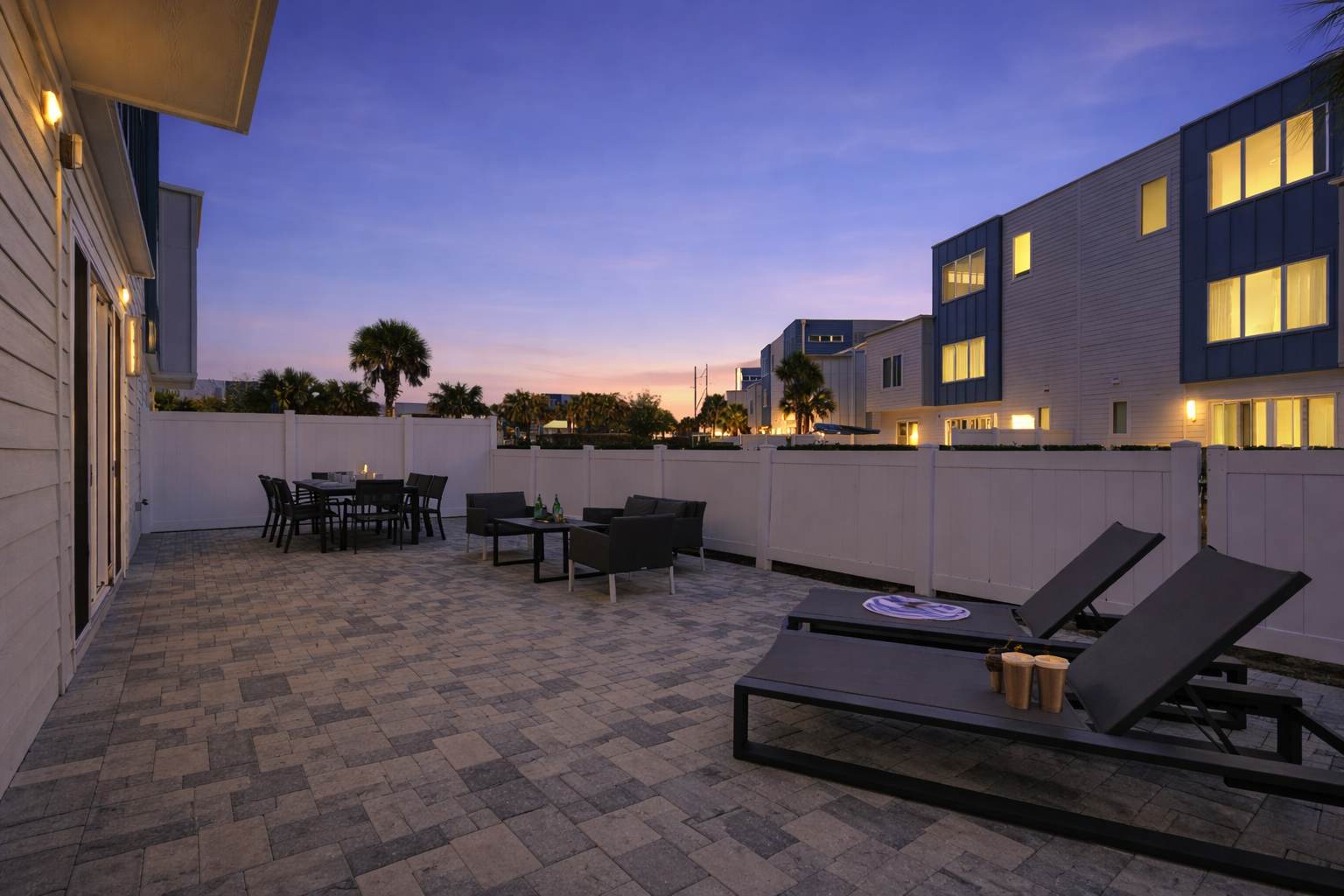 Spacious outdoor patio with lounge chairs and dining area for relaxing evenings.