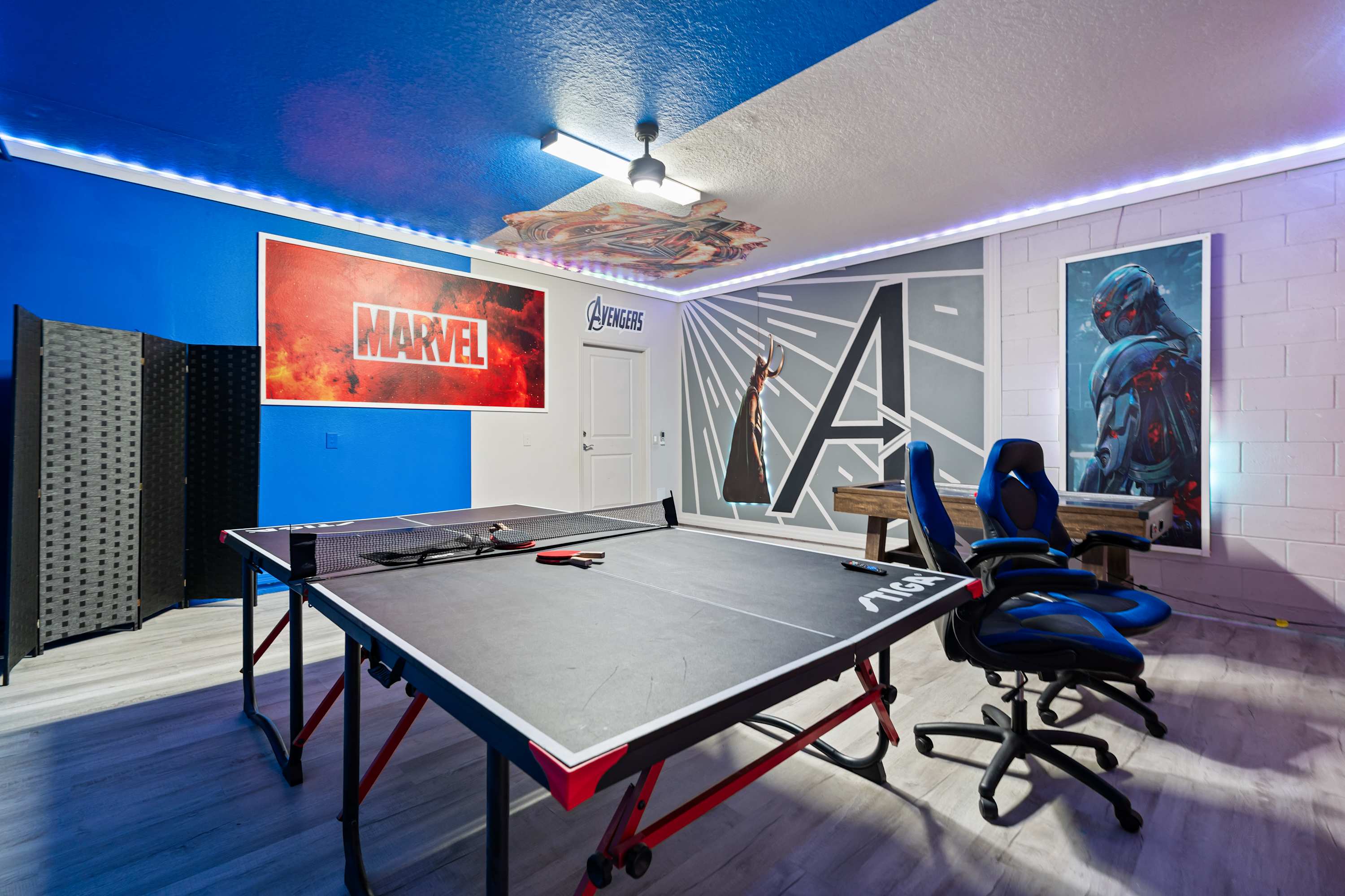 Marvel-themed playroom featuring ping pong and air hockey for fun with family and friends