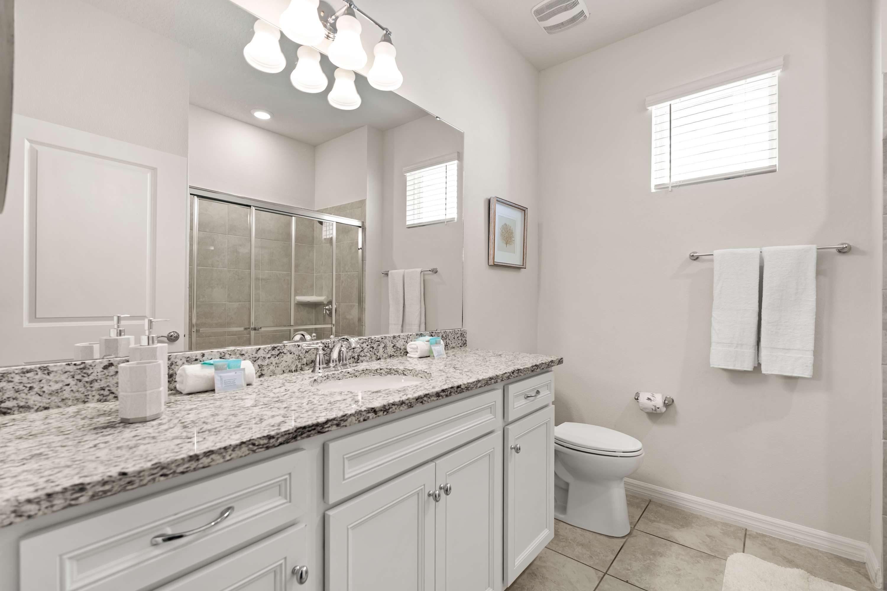 Bathroom with walk-in shower and essentials, perfect for a refreshing and convenient stay