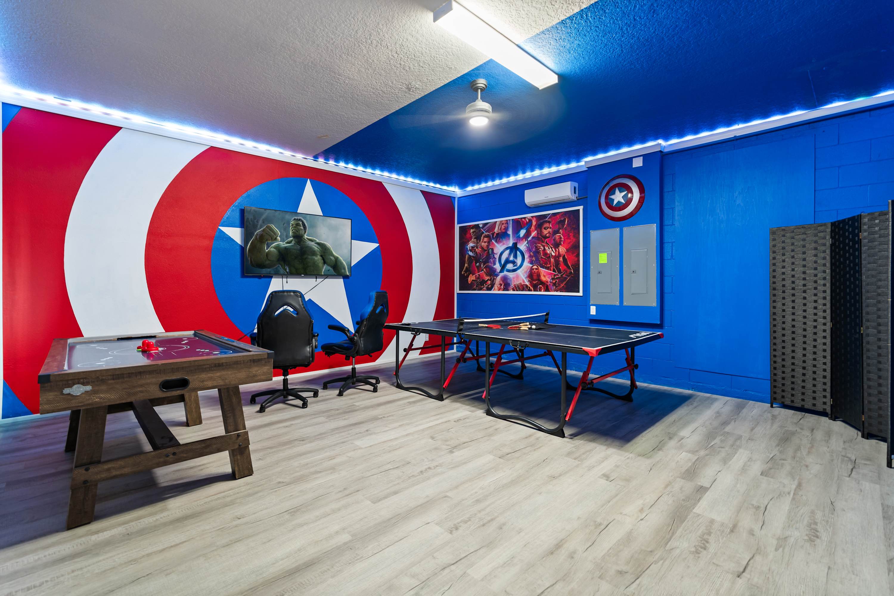 Full game room with TV, game chairs, and activities for fun with family and friends