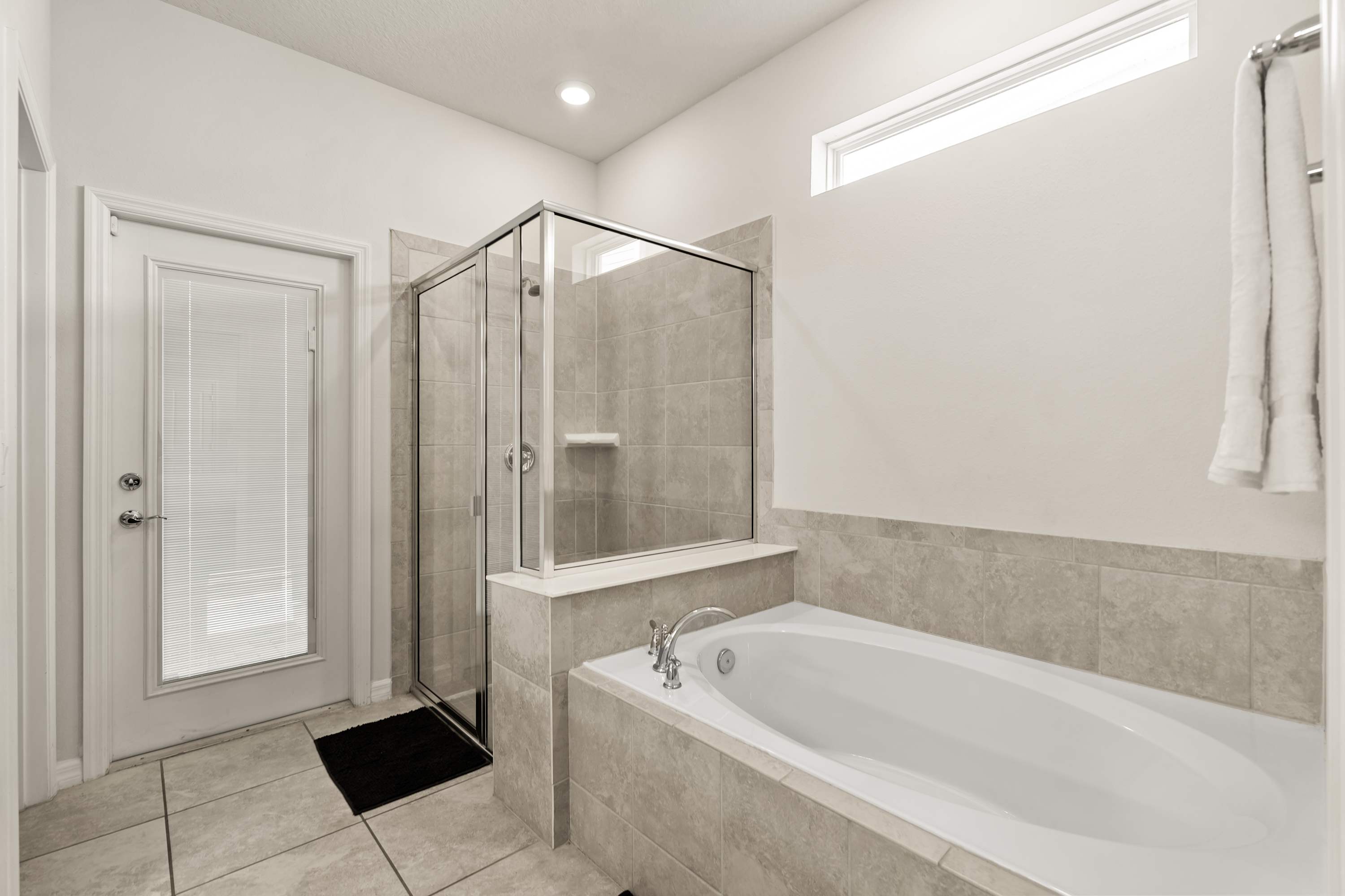 Bathroom with bathtub and walk-in shower, perfect for relaxing and refreshing after a long day