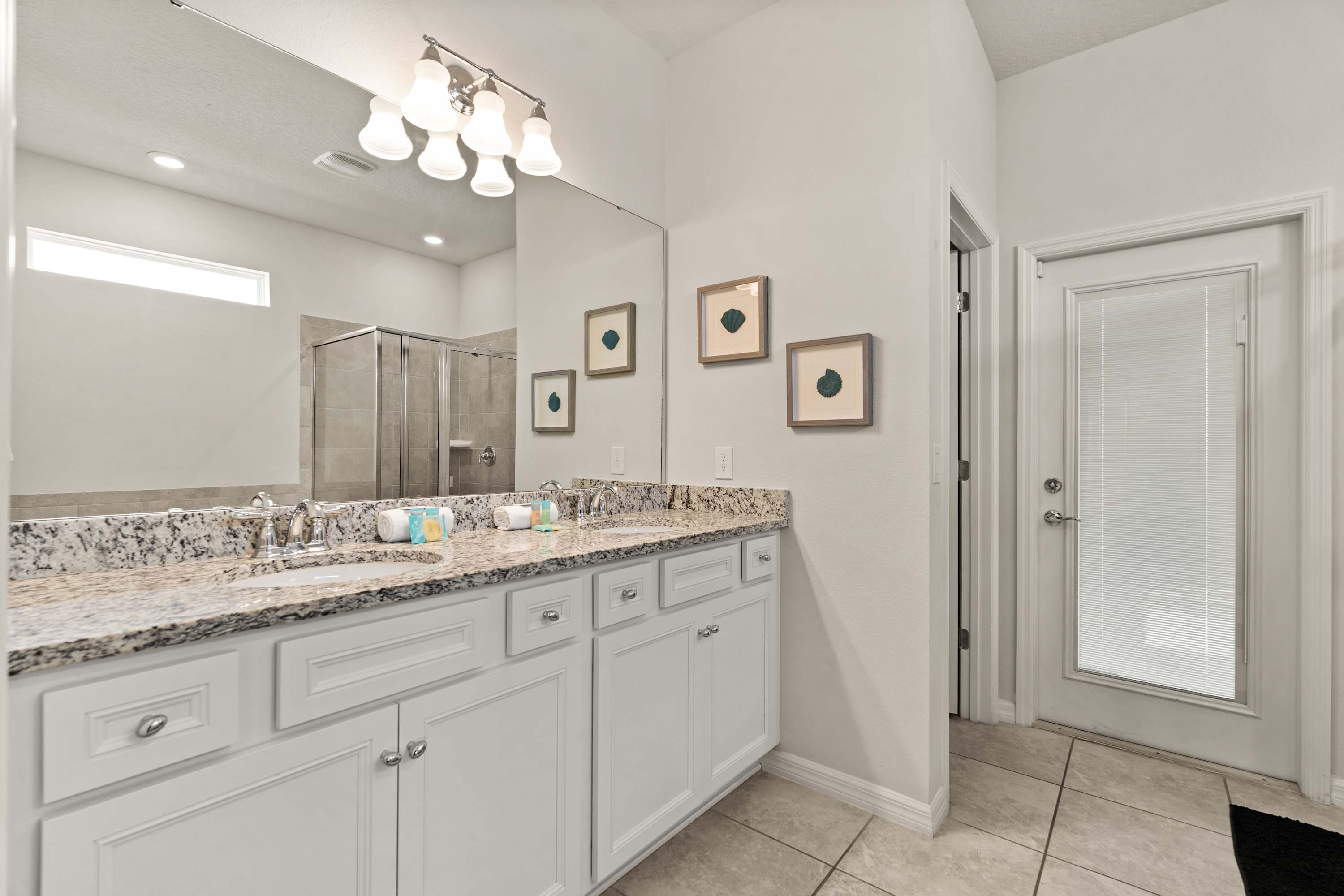 Well-lit bathroom with double sinks and mirror, ideal for getting ready with ease and comfort