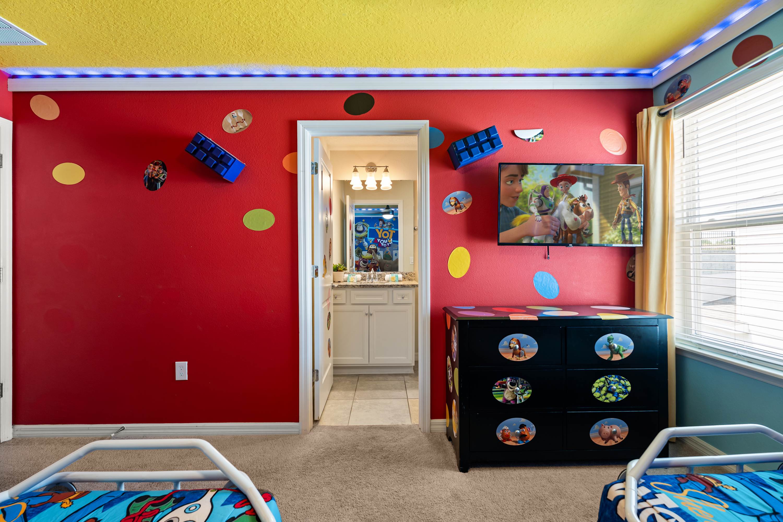 Toy Story room with TV for shows and bathroom for quick, fun, and easy refresh