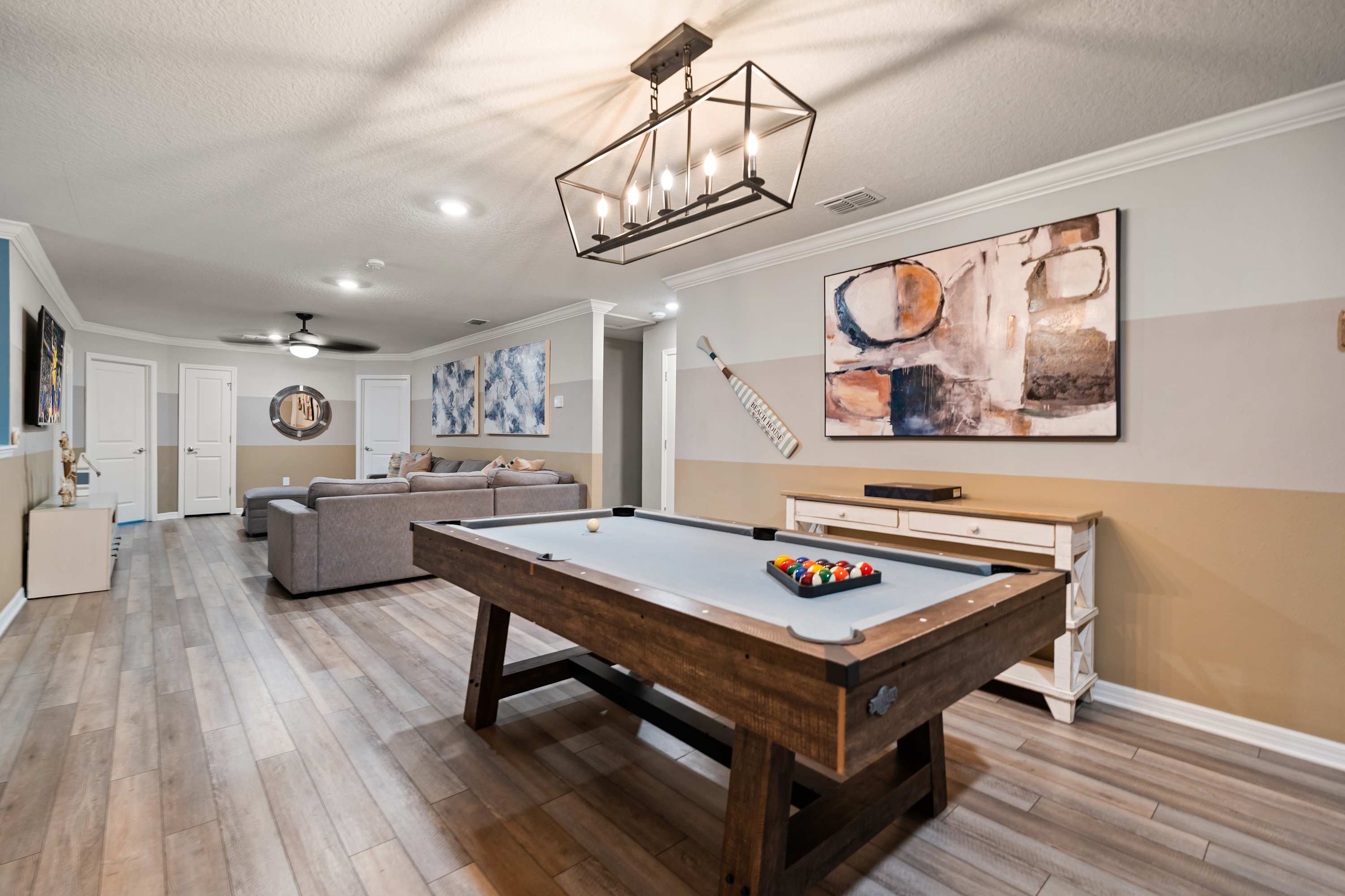 Billiard table flowing into living area where family and friends can relax, play, and connect