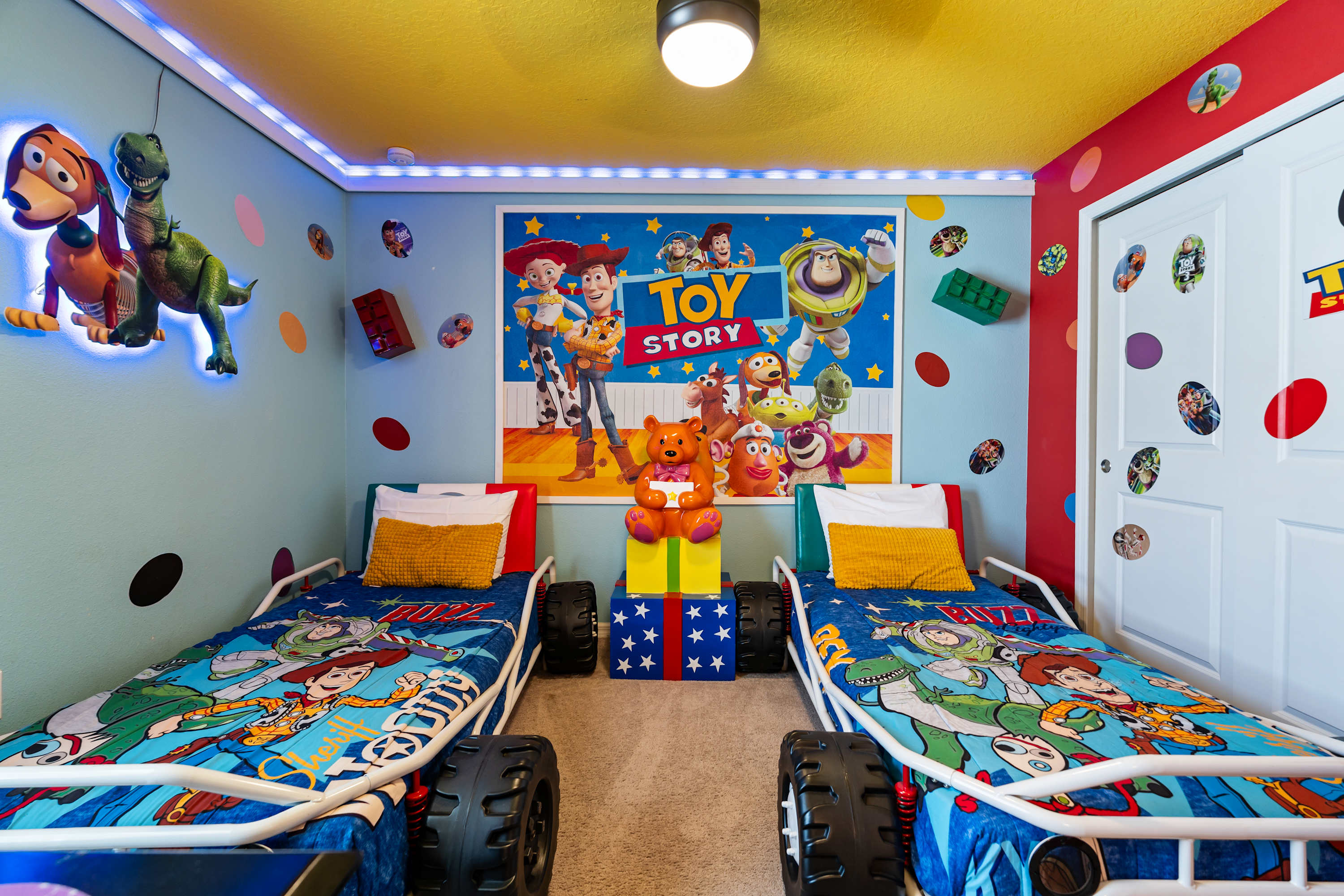 Toy Story room with two single car-shaped beds where kids can play, imagine, and drift to sleep