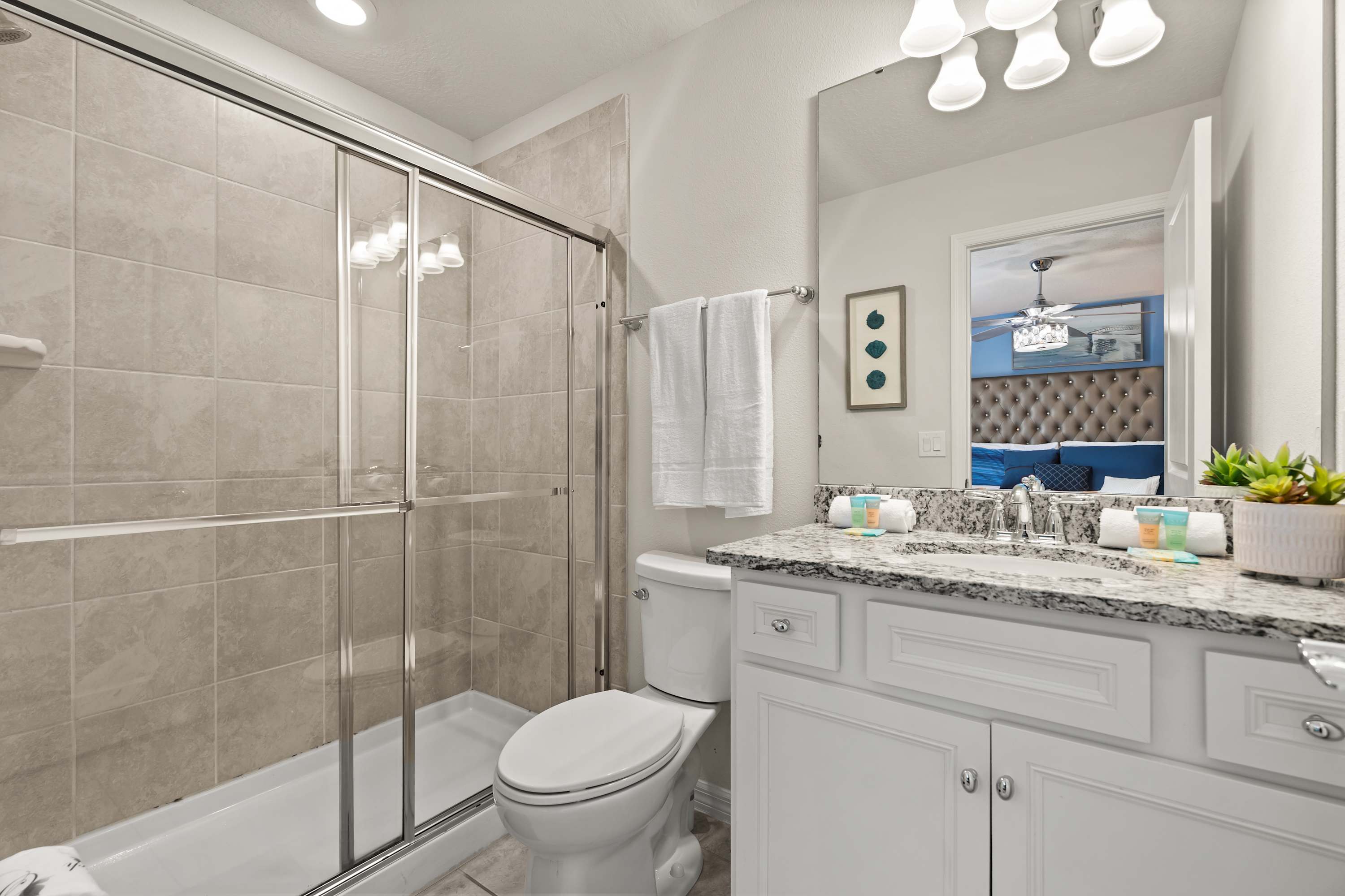 Well-lit bathroom with walk-in shower and amenities for a refreshing and comfortable stay