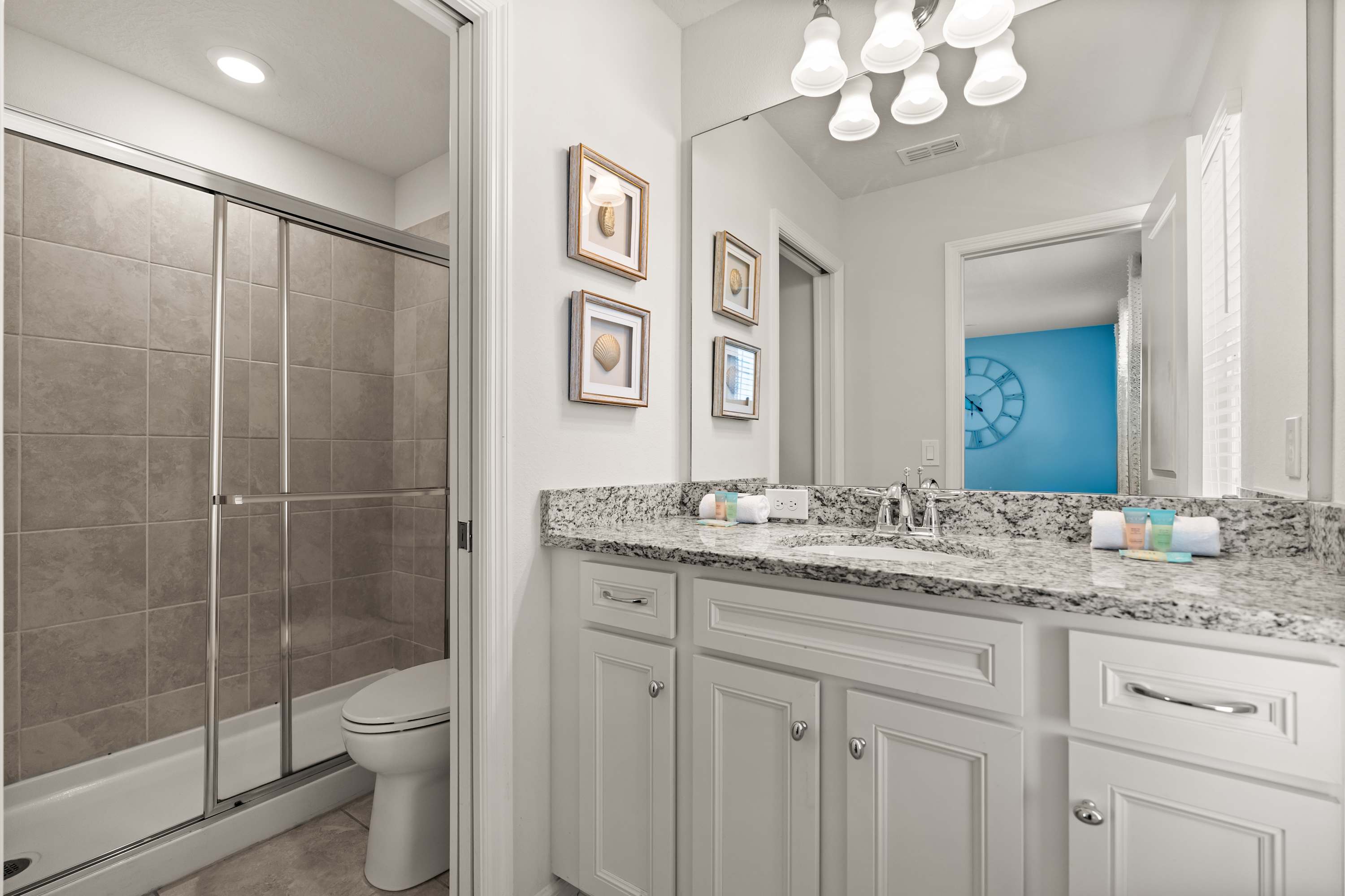 Bathroom with walk-in shower, sink area, and essentials for refreshing and getting ready