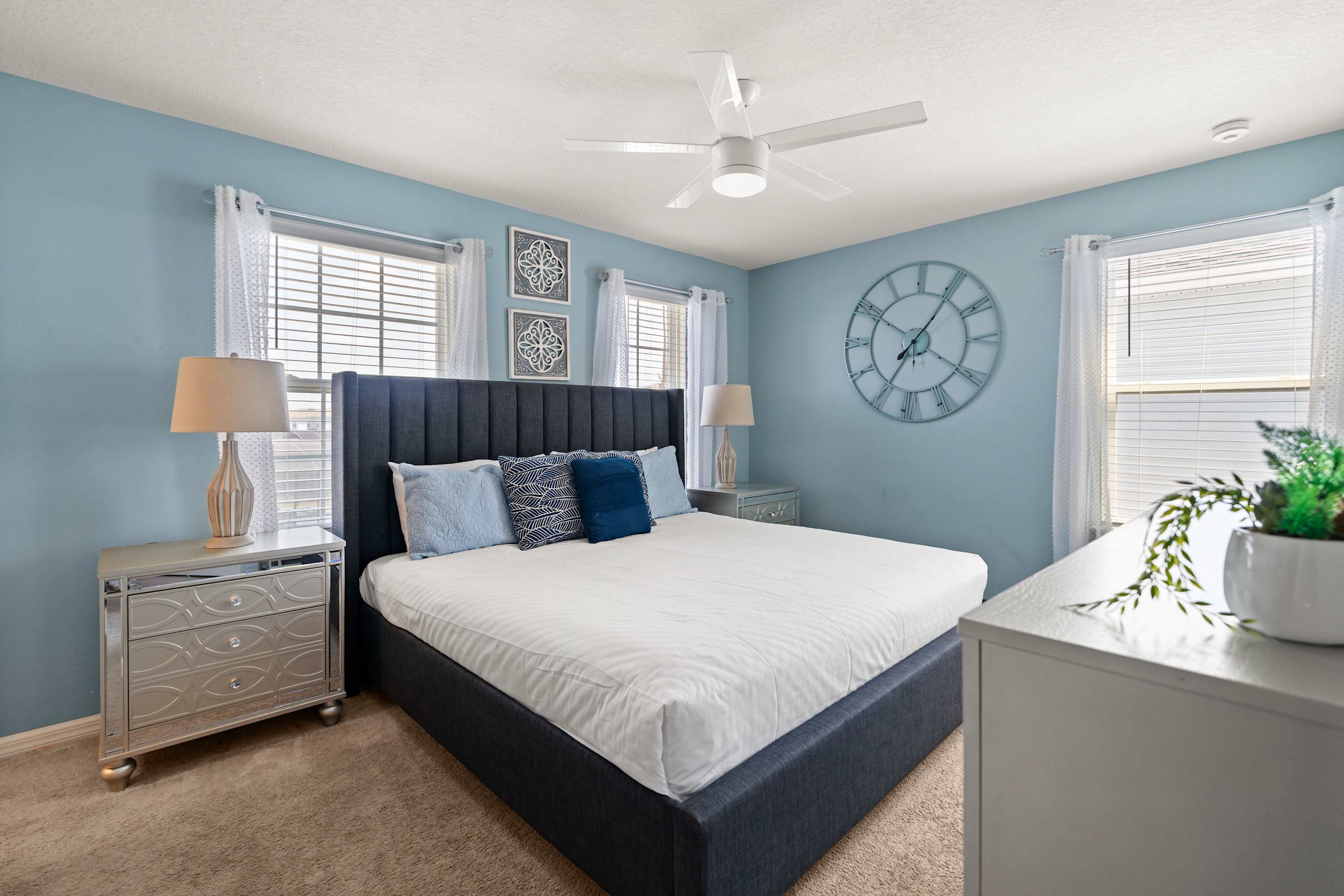 King bedroom with cozy lighting and headboard, perfect for relaxing, reading, or unwinding