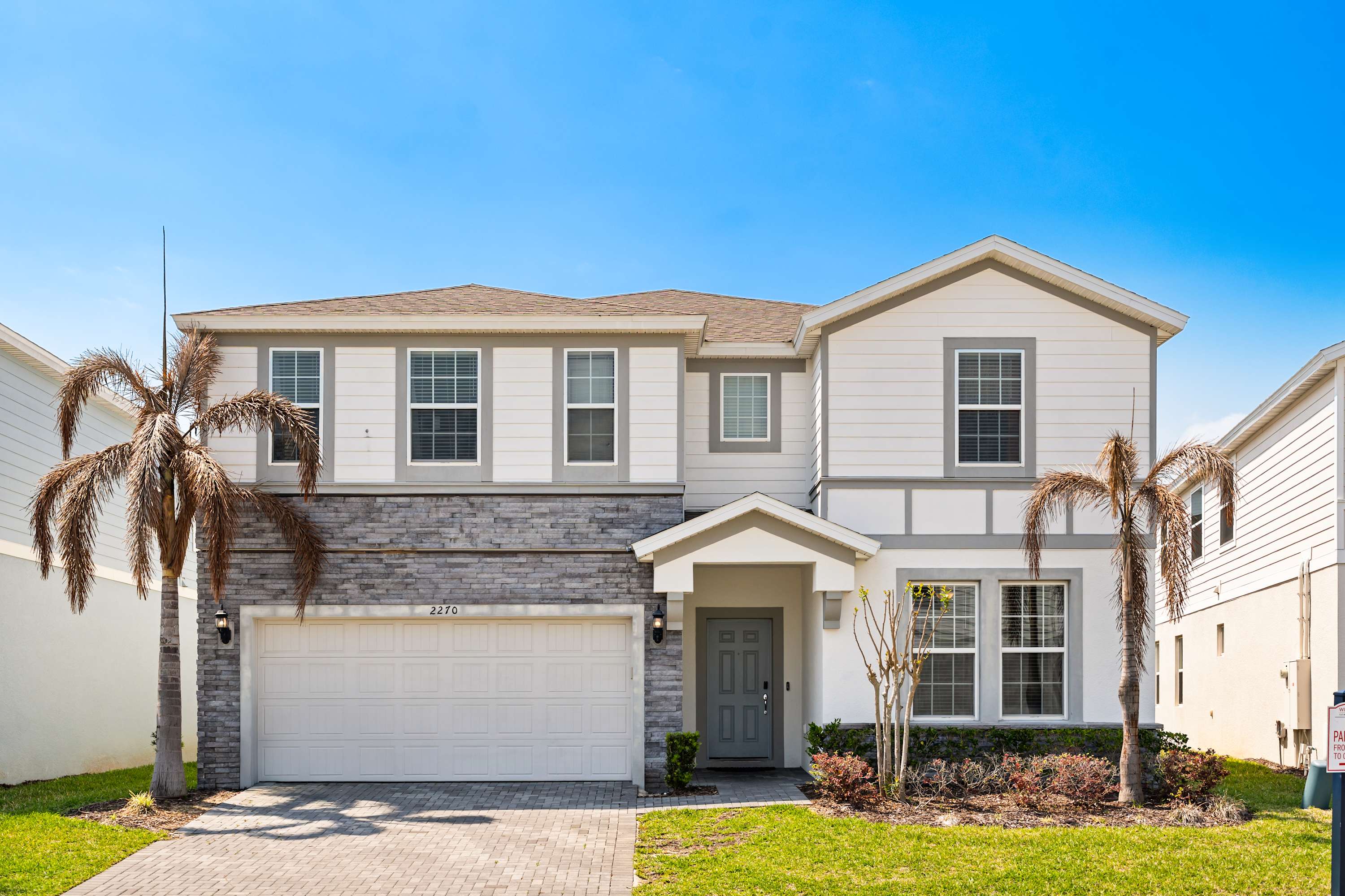 Modern two-story home with garage and parking space for 2 cars