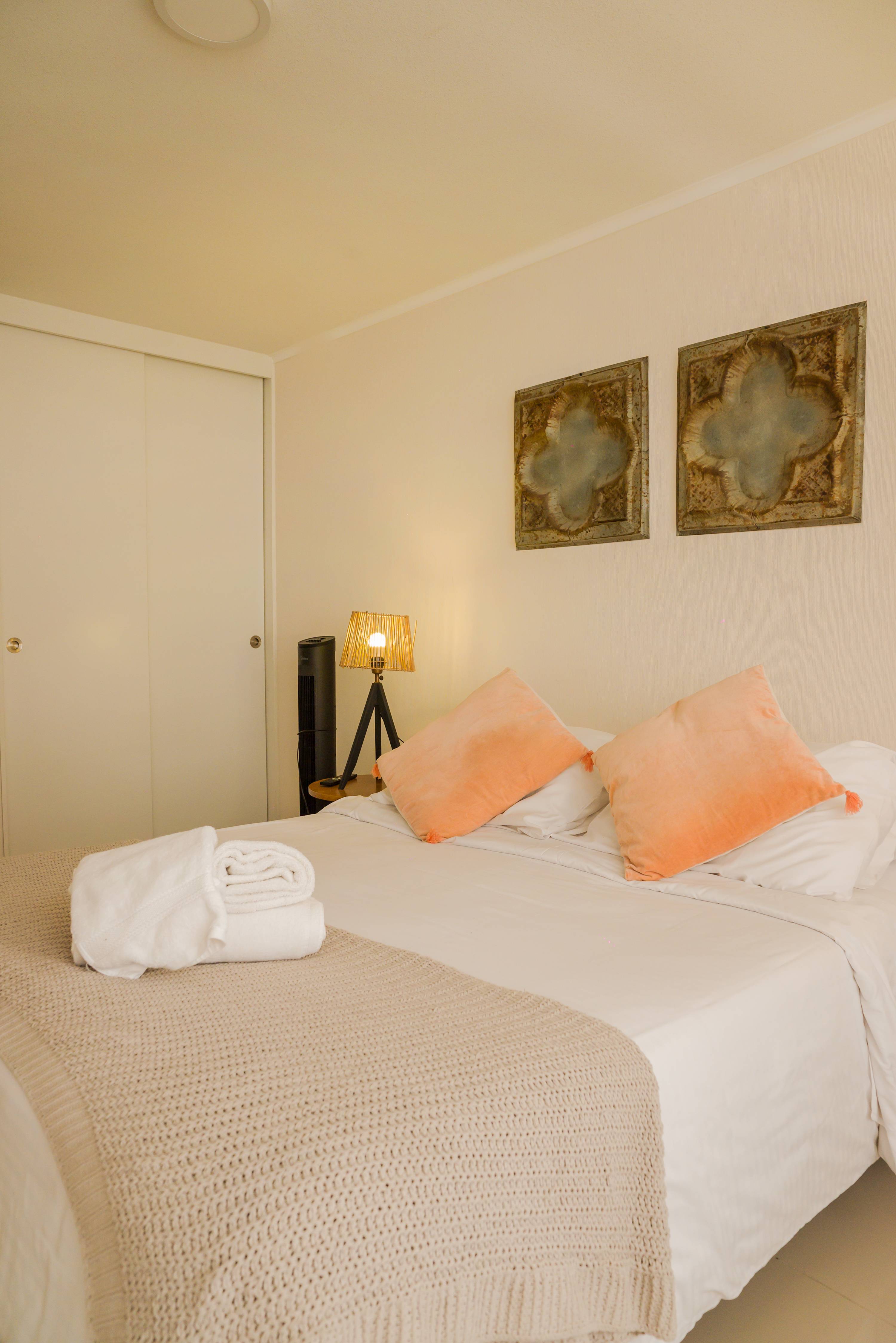 Relax in this cozy bedroom with warm lighting and stylish decor, perfect for a restful stay.