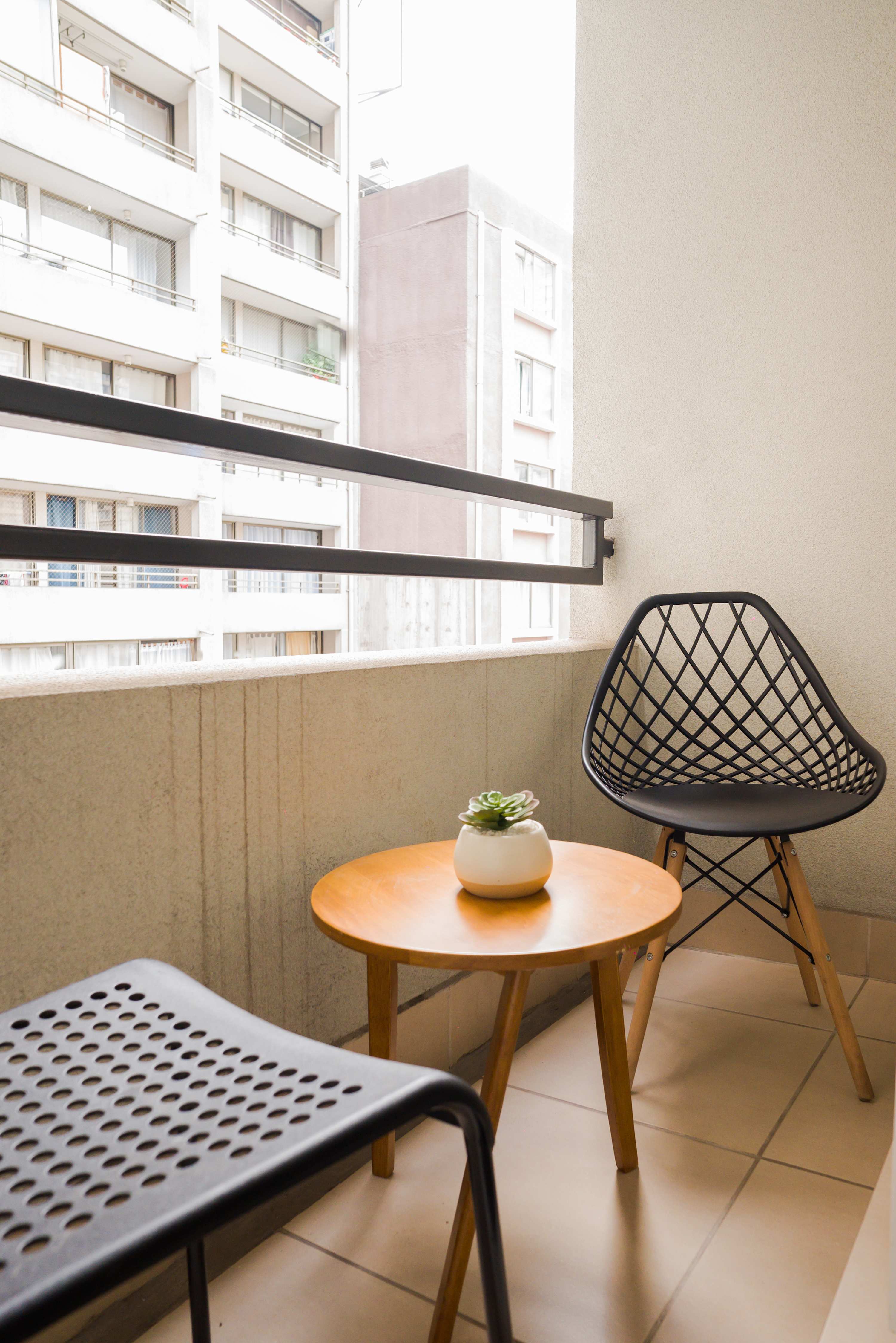 Cozy private balcony perfect for enjoying a morning coffee with city views.