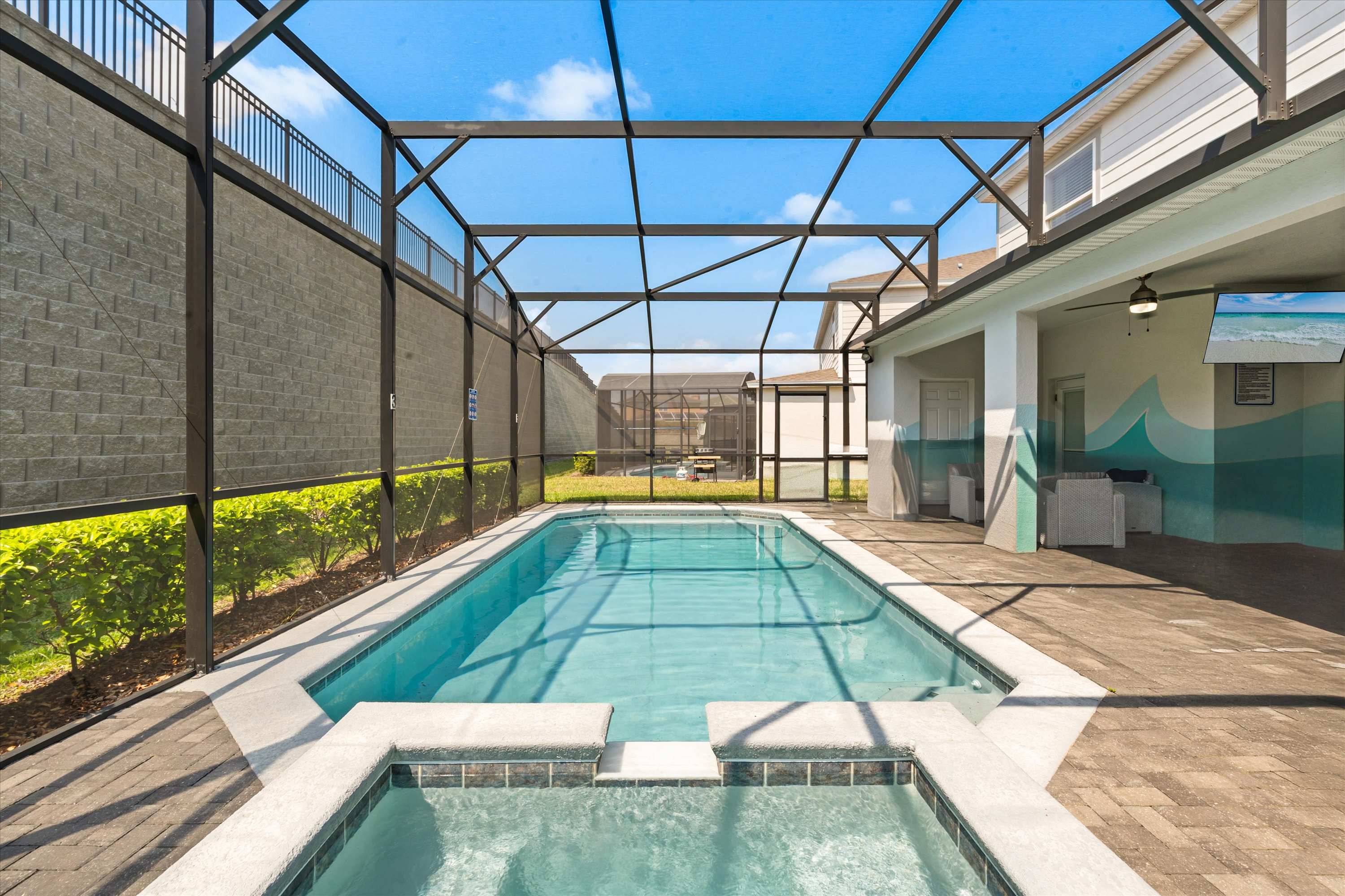 Large pool with hot tub for family fun, swimming, and relaxing together