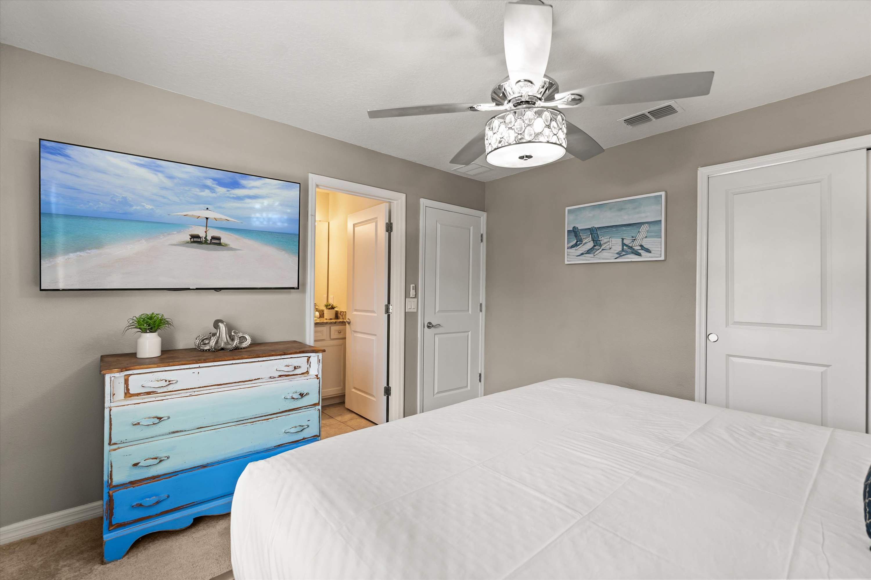 King bedroom with 65-inch smart TV and bathroom, perfect for relaxing, watching shows, and recharging