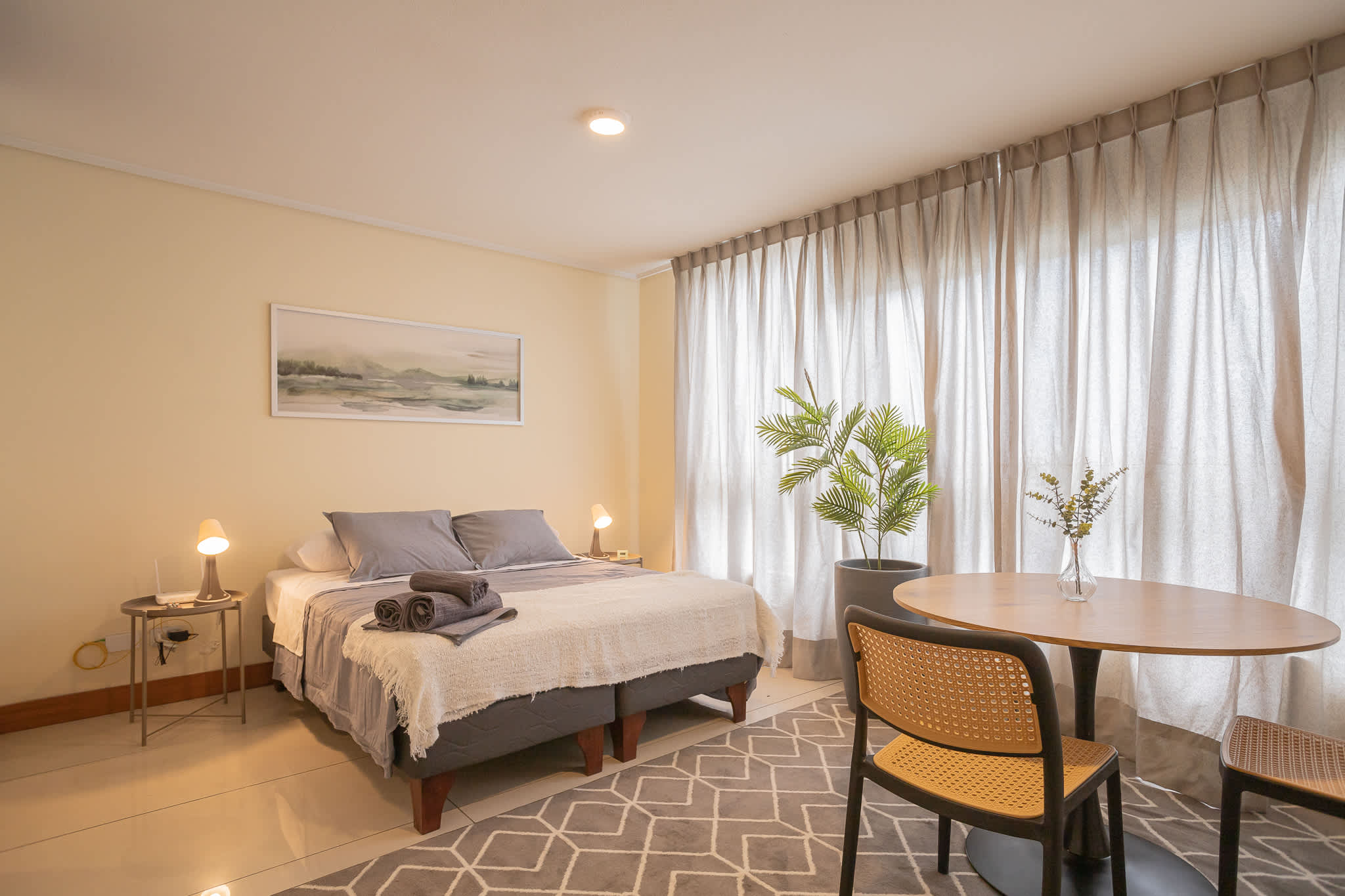Experience comfort in this stylish studio with cozy bedding, a dining nook, and abundant natural light.