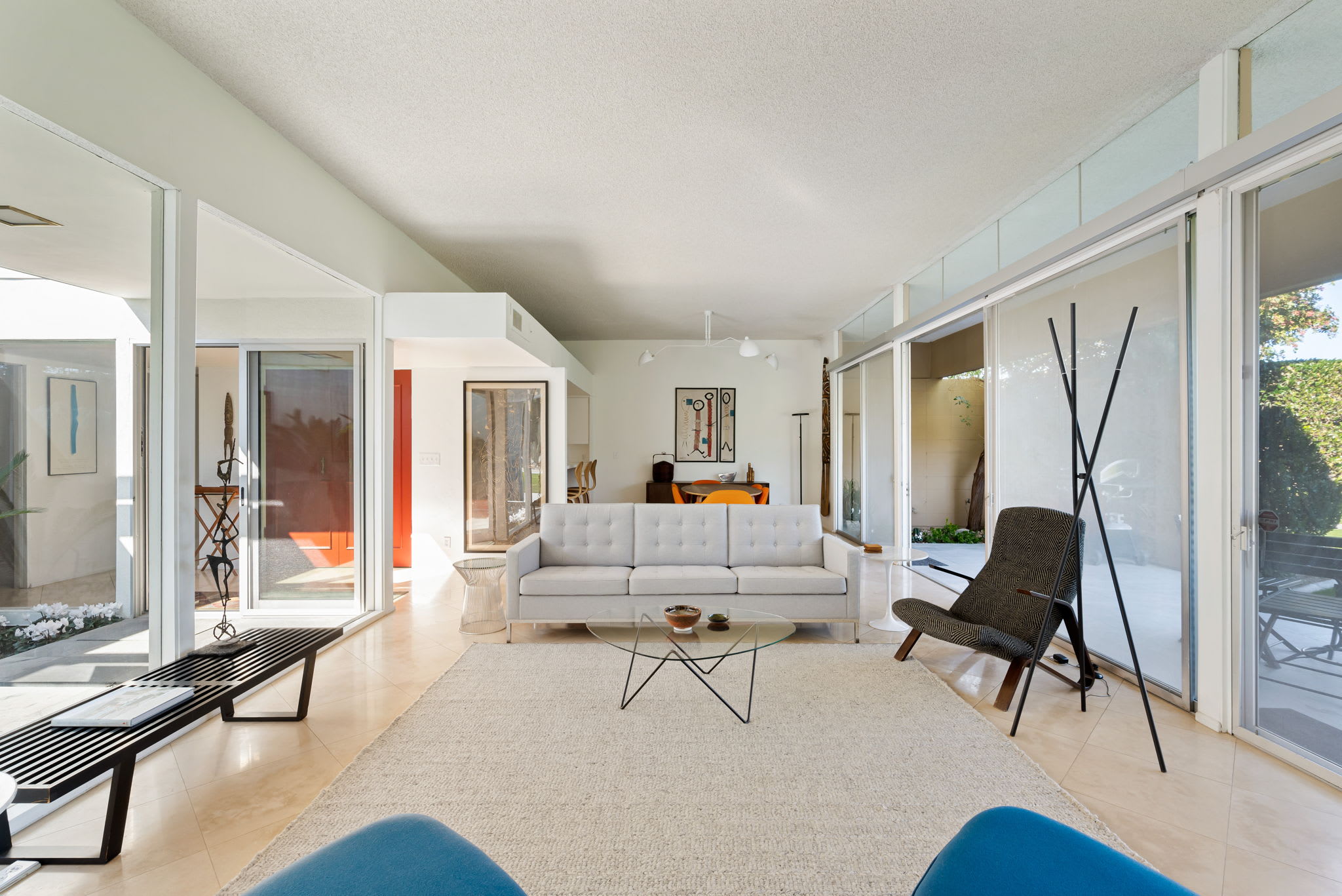 Living room with sofa seating, a coffee table and full-height glass doors.