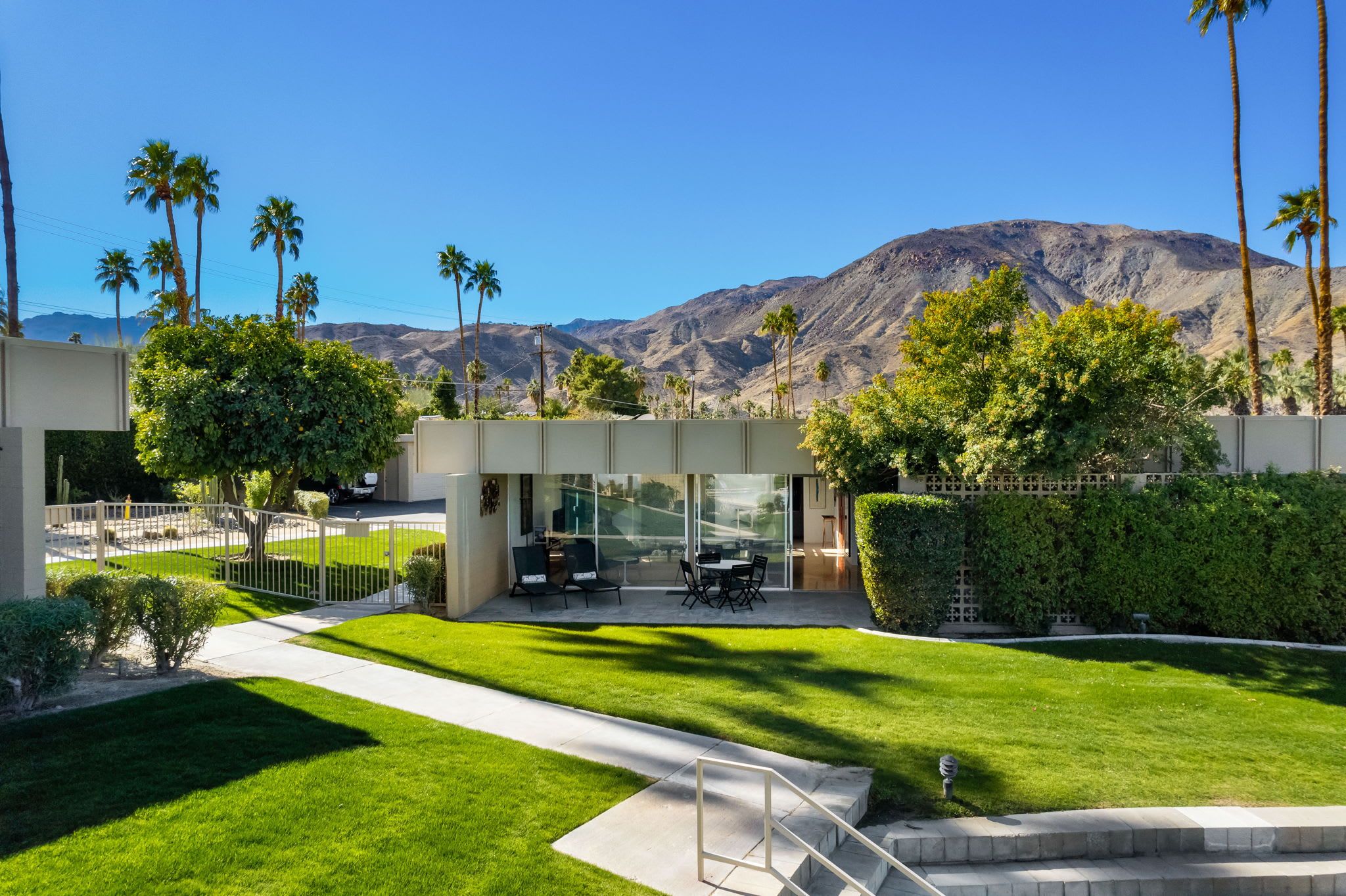 Rear lawn, outdoor seating and mountain backdrop.