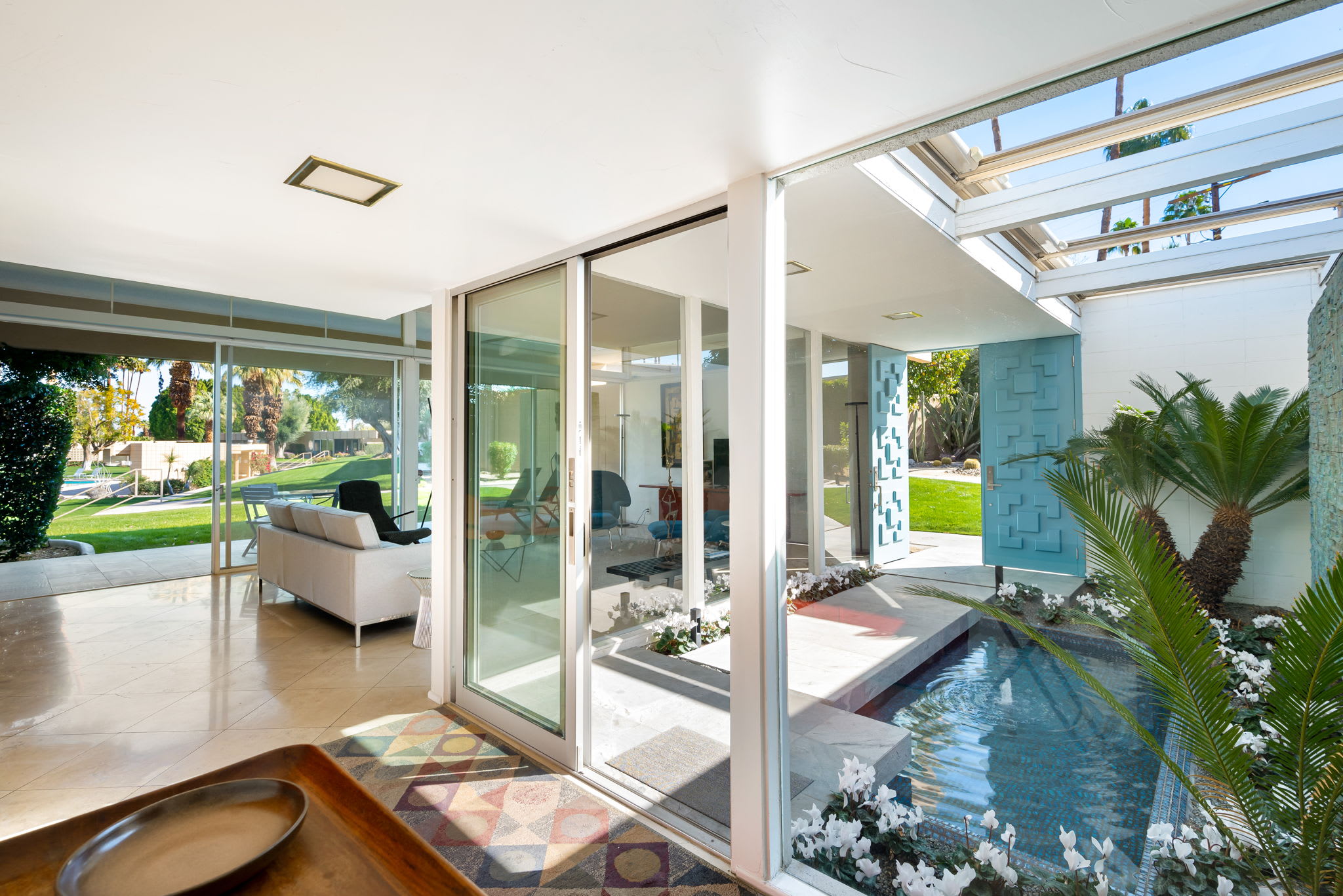 View between the living area and front courtyard through sliding glass doors.