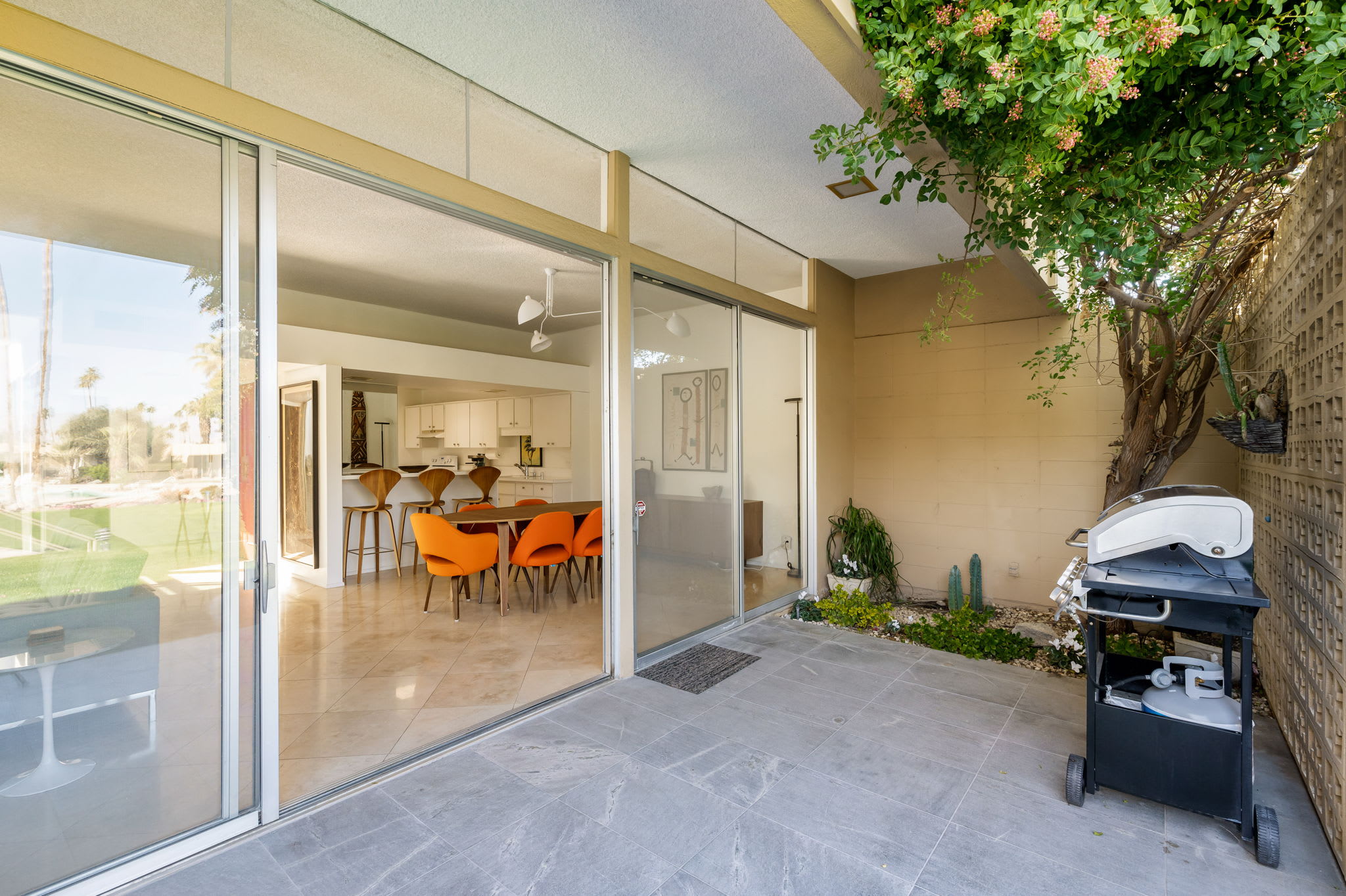 Rear patio and barbecue beside sliding doors to the dining area.