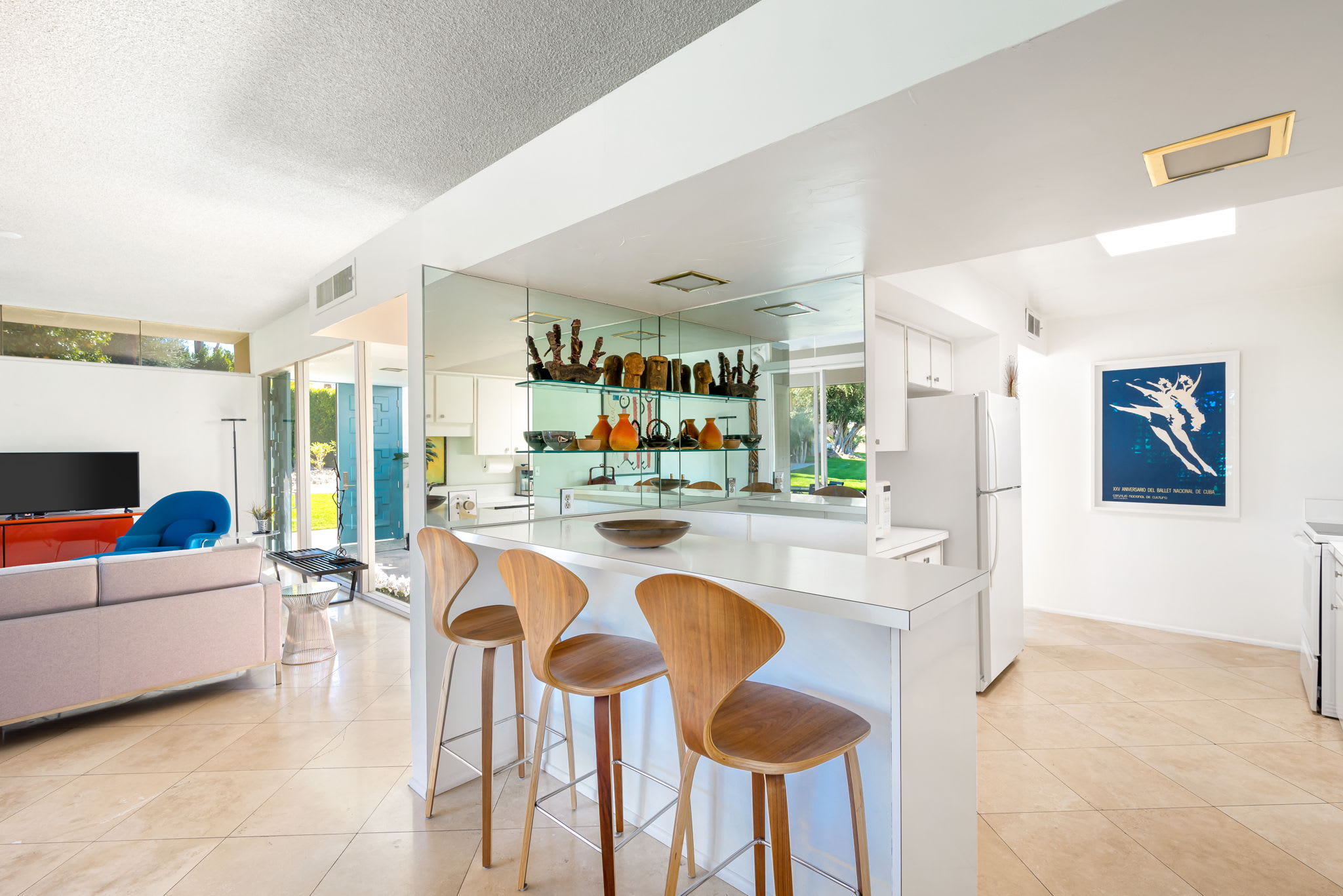 Open kitchen breakfast bar with stools adjoining the living area.