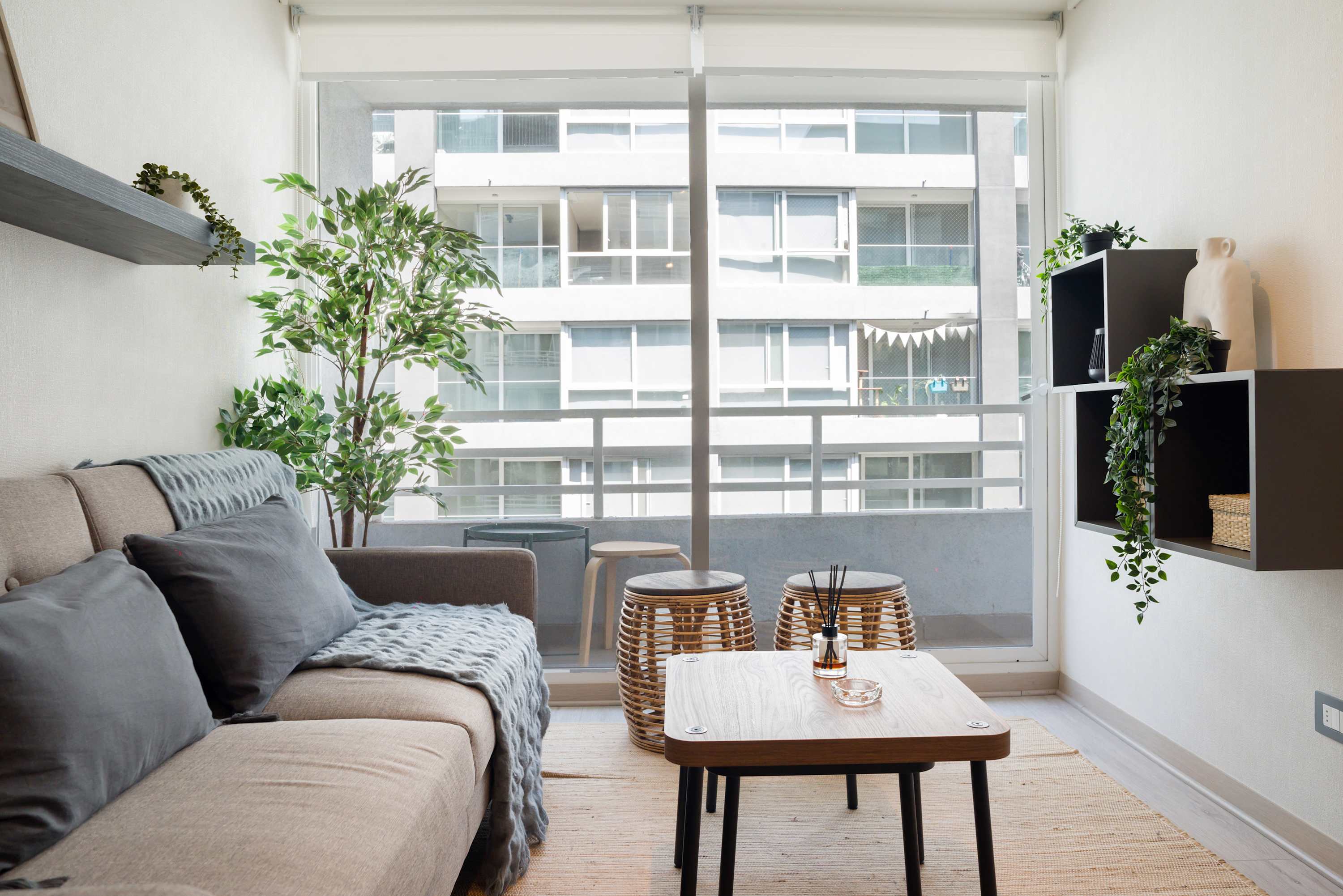 Relax in this cozy living space with a bright balcony view, perfect for unwinding after exploring the city.
