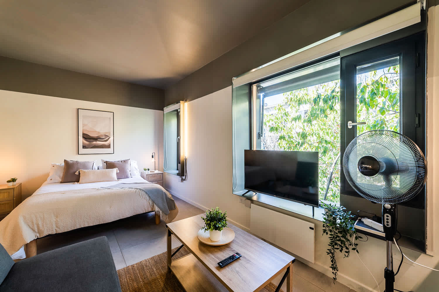 Bright and cozy studio with natural light, modern decor, and a comfortable bed. Perfect for a relaxing stay.