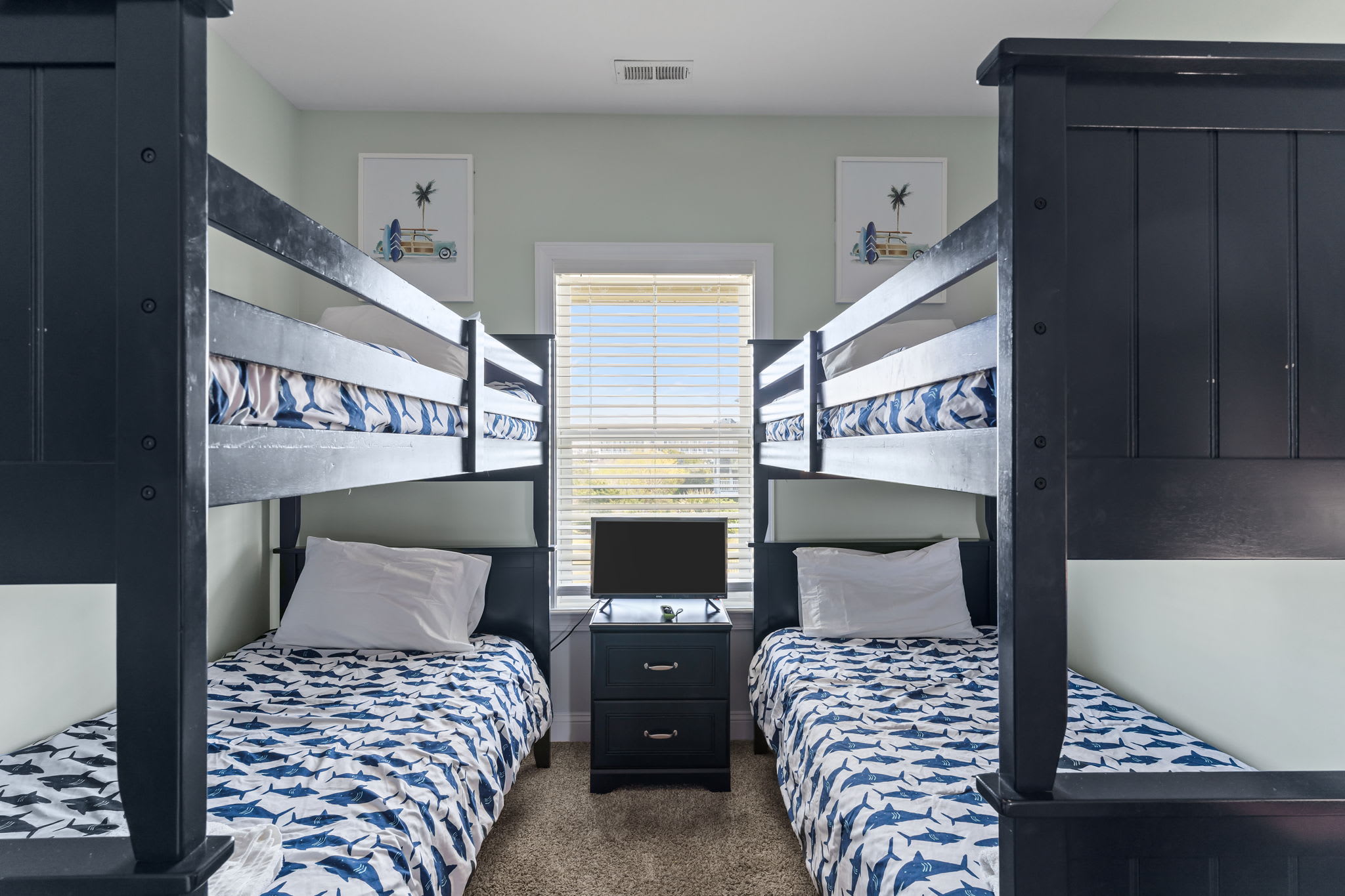 Little Surfers Welcome! Books and toys in kids bunk room as well