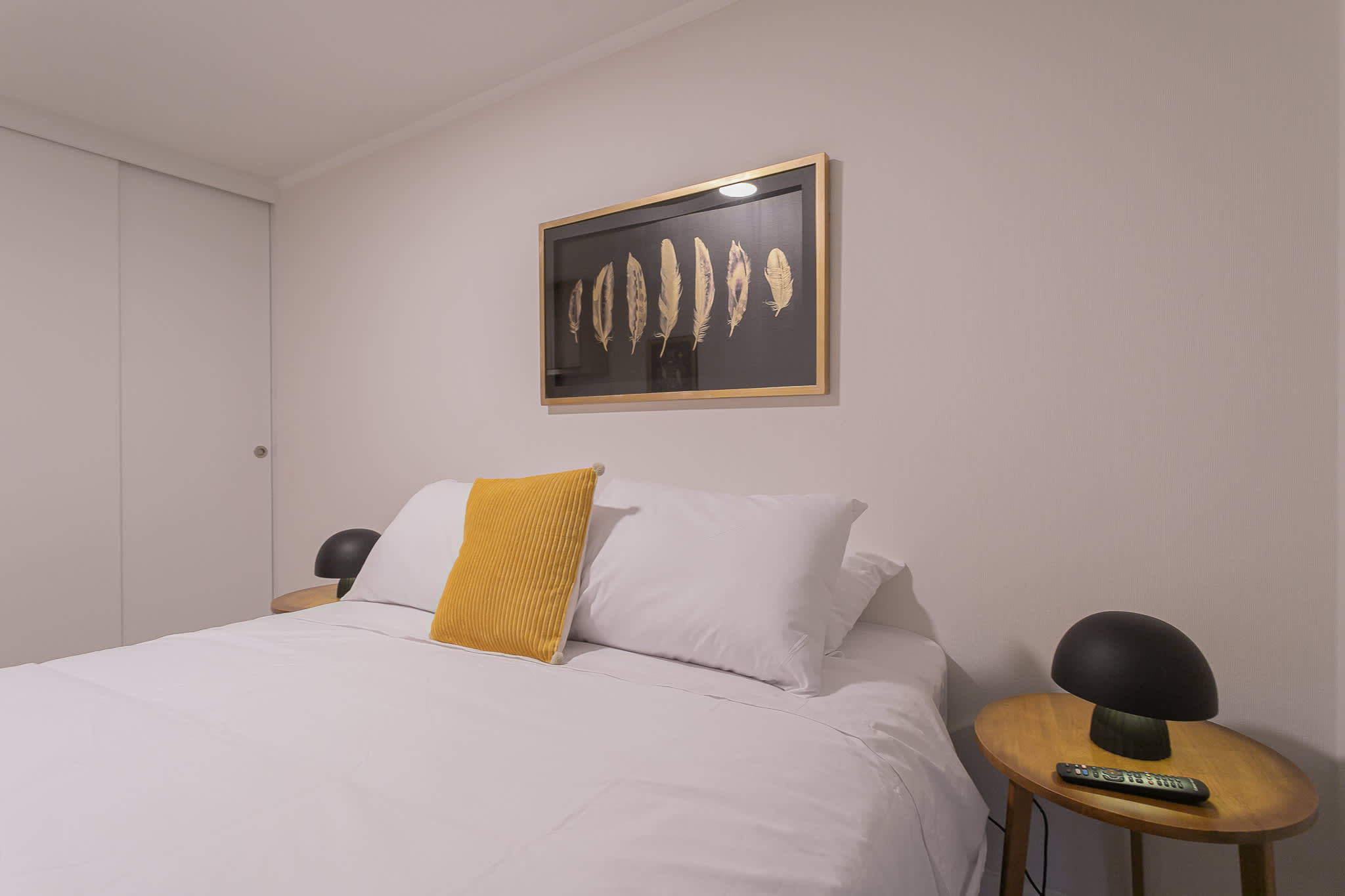 Cozy studio bedroom with modern decor and a touch of elegance, perfect for a relaxing stay.
